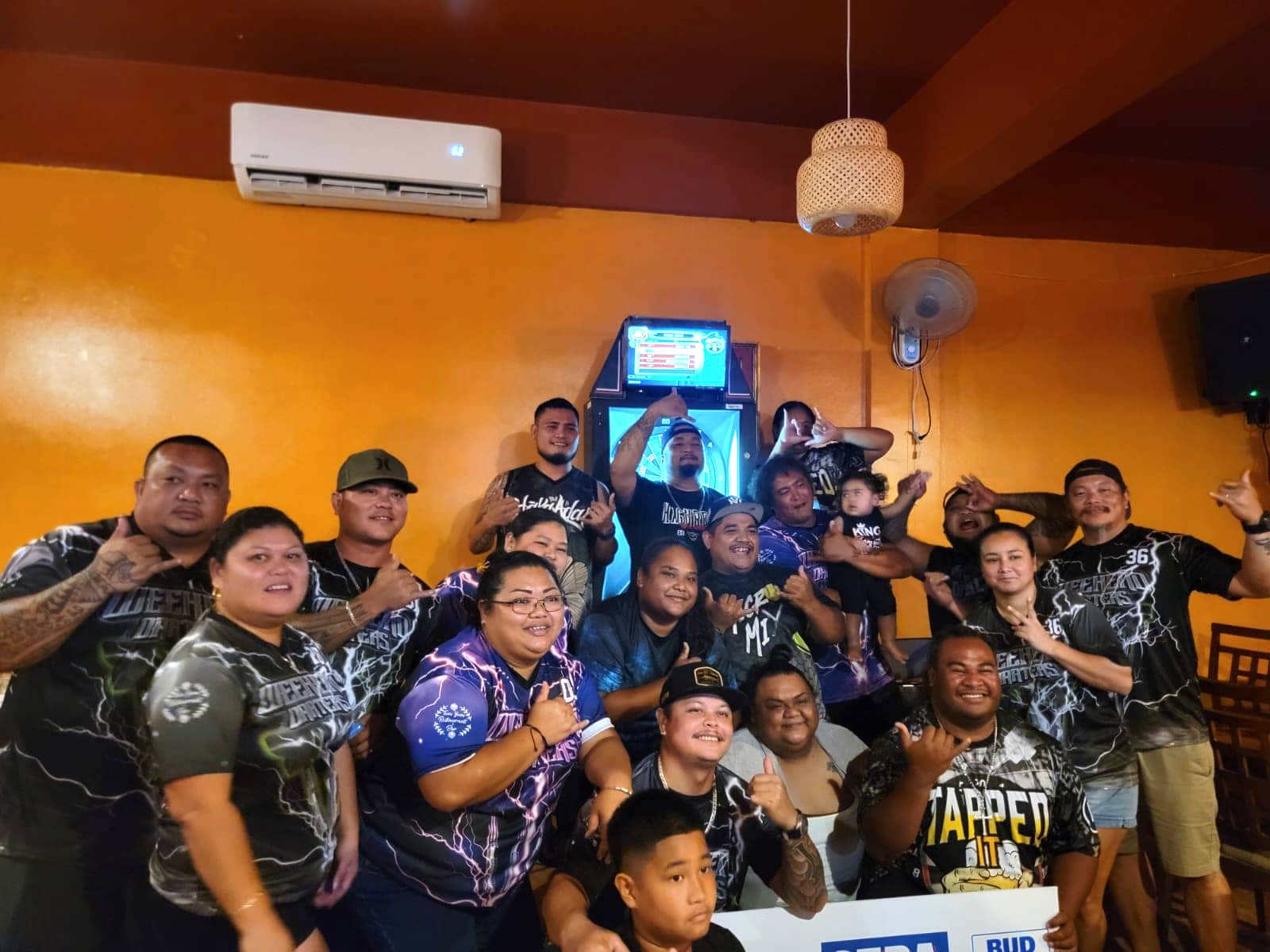Tapped Out Tapped It and Tom Yum Weekend Darters pose for a group photo after the conclusion of the Bud Light Cup championship match in the co-ed division of the 2024 SEDA Bud Light Dart League at the Tom Yum Restaurant on Saturday.
