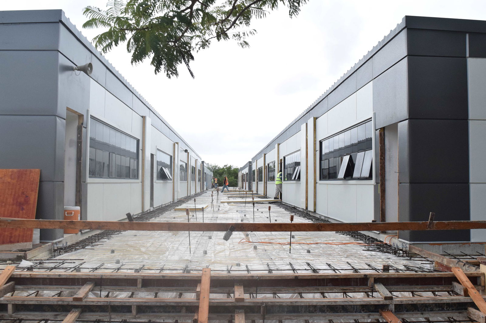 Five Star Builders employees apply the finishing touches to the newly installed modular classrooms of Admiral Herbert G. Hopwood Middle School in San Antonio on Tuesday.