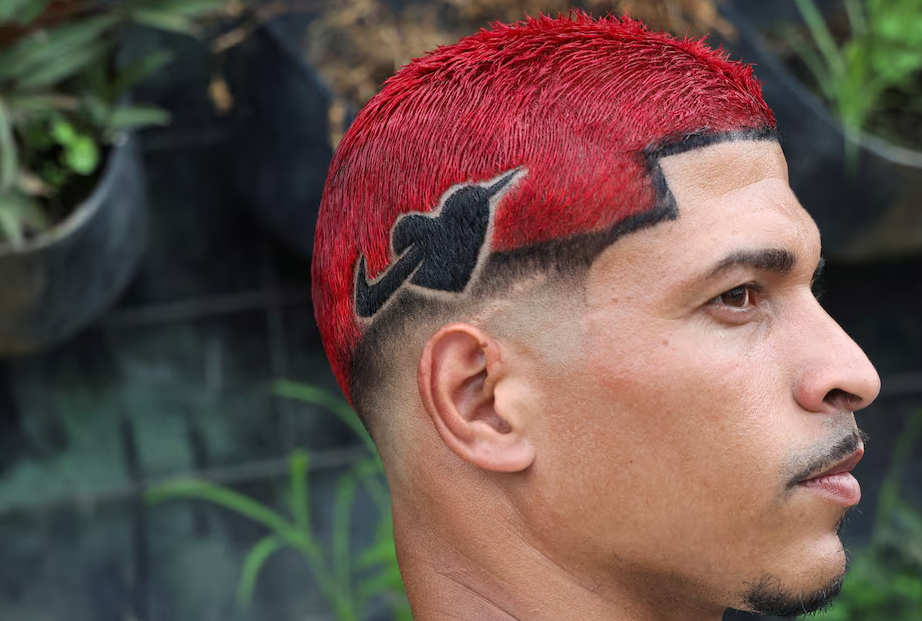 A man shows one of the winning haircuts during a barbers' battle contest for best haircut in Rio de Janeiro, Brazil, Dec. 15, 2024.