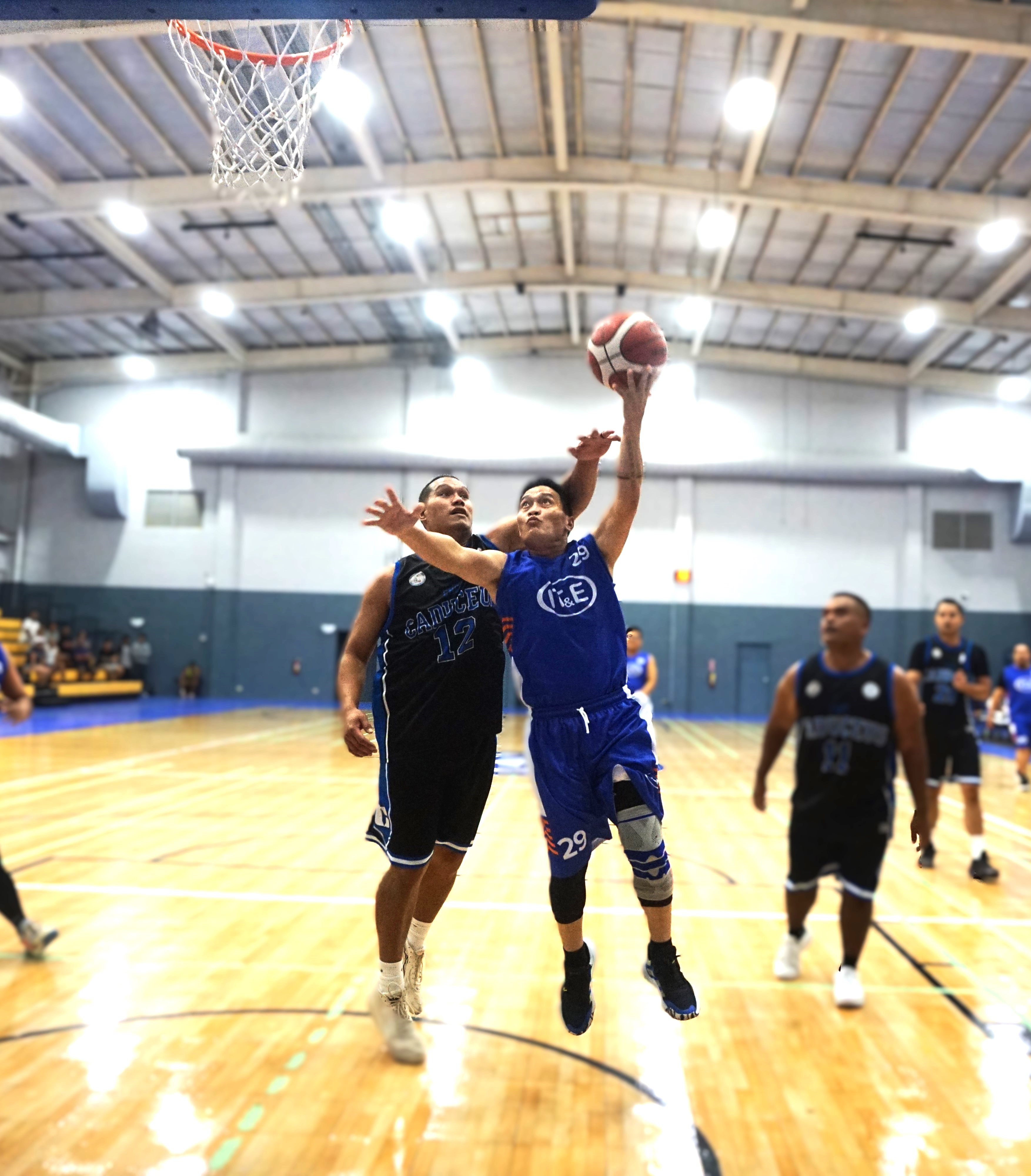 IT&E's Rodolfo Singca extends for the finish against CHCC’s Jack Lizama during a game of the 2024 R&J Wine and Liquor Inter-Government/Business League at the Ada gym on Saturday. 