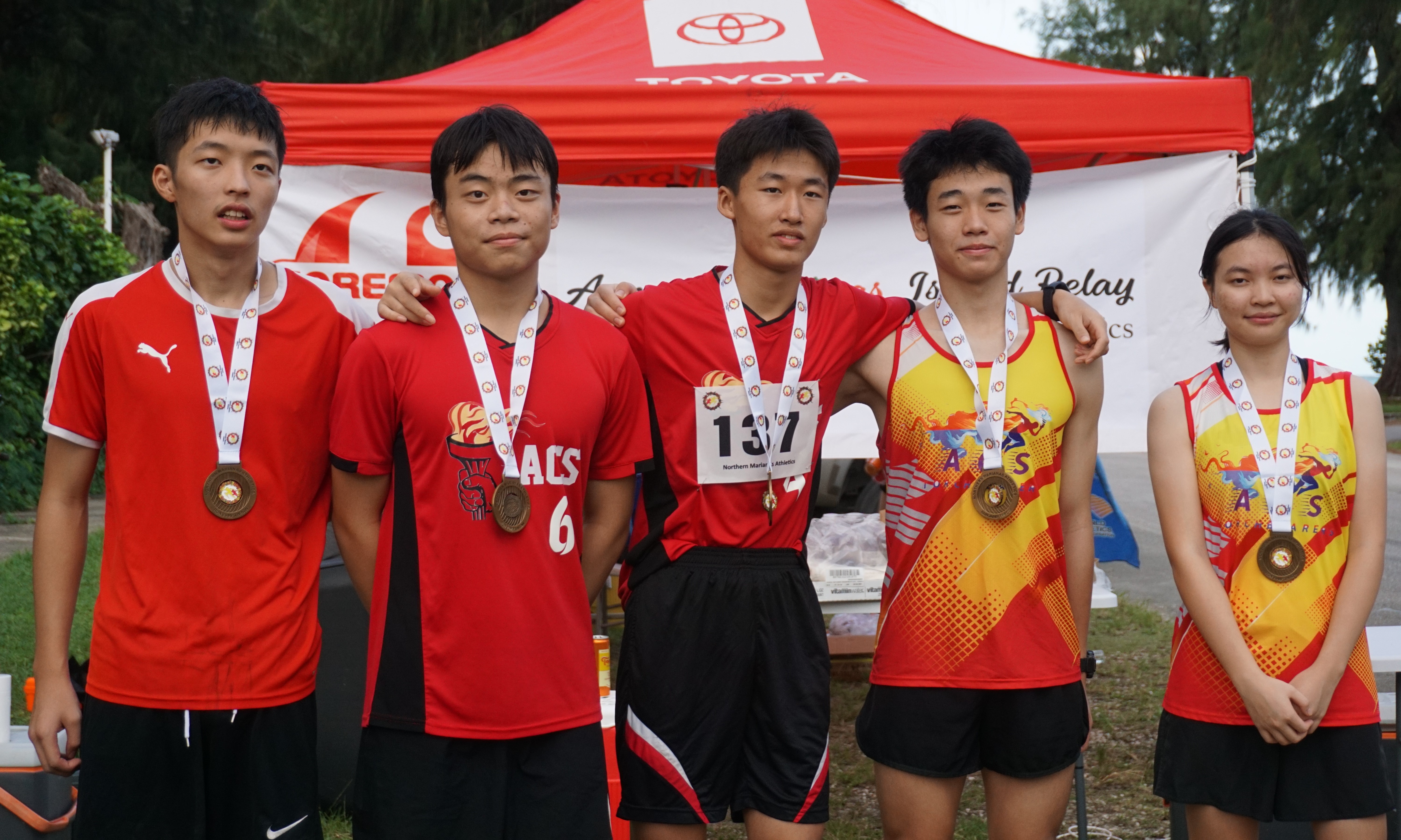 Agape Youth Team members pose with their first-place medals in the youth division.
