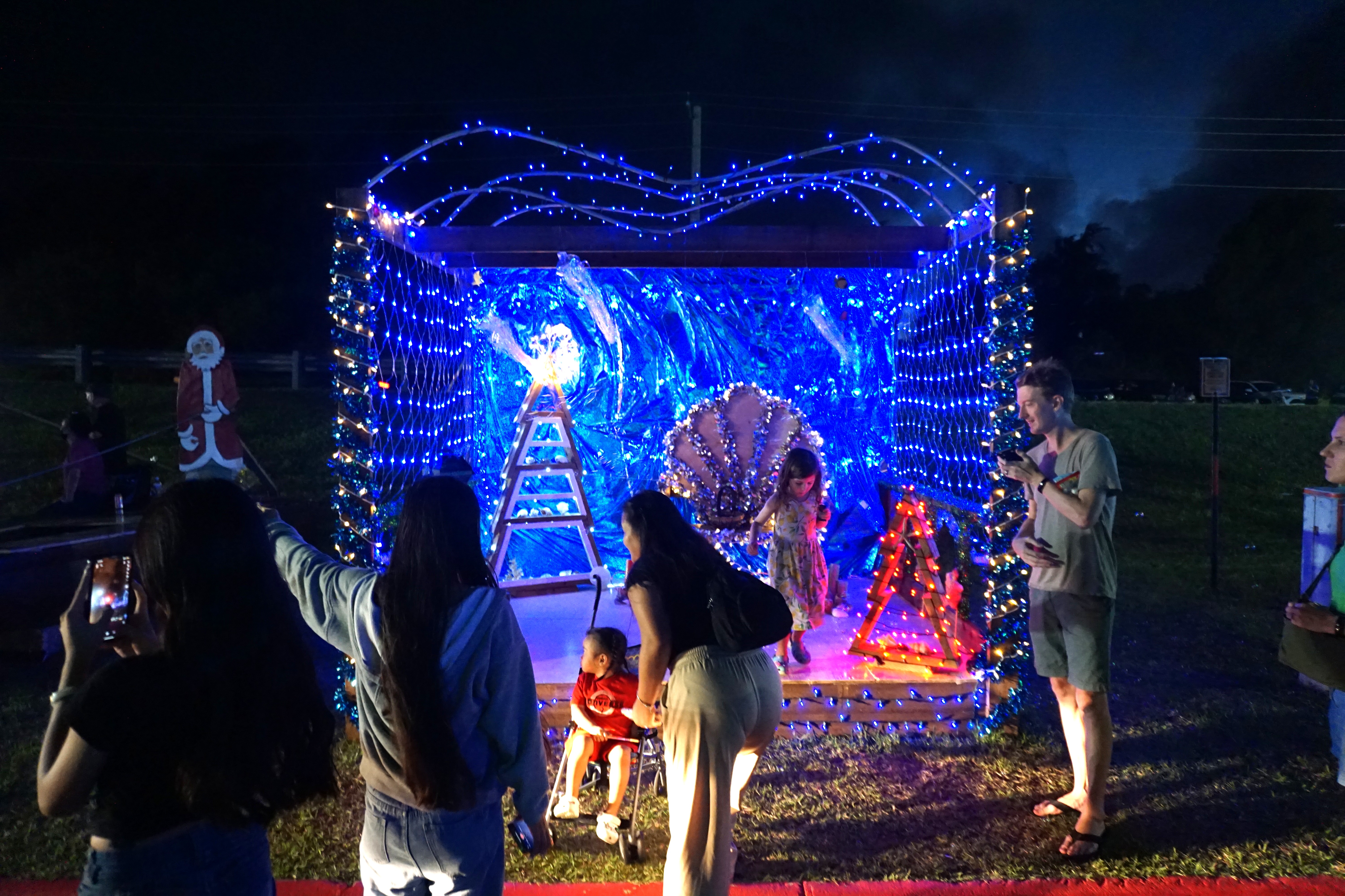 Families coordinate to take their children’s pictures at one of the Christmas displays on Capital Hill. 