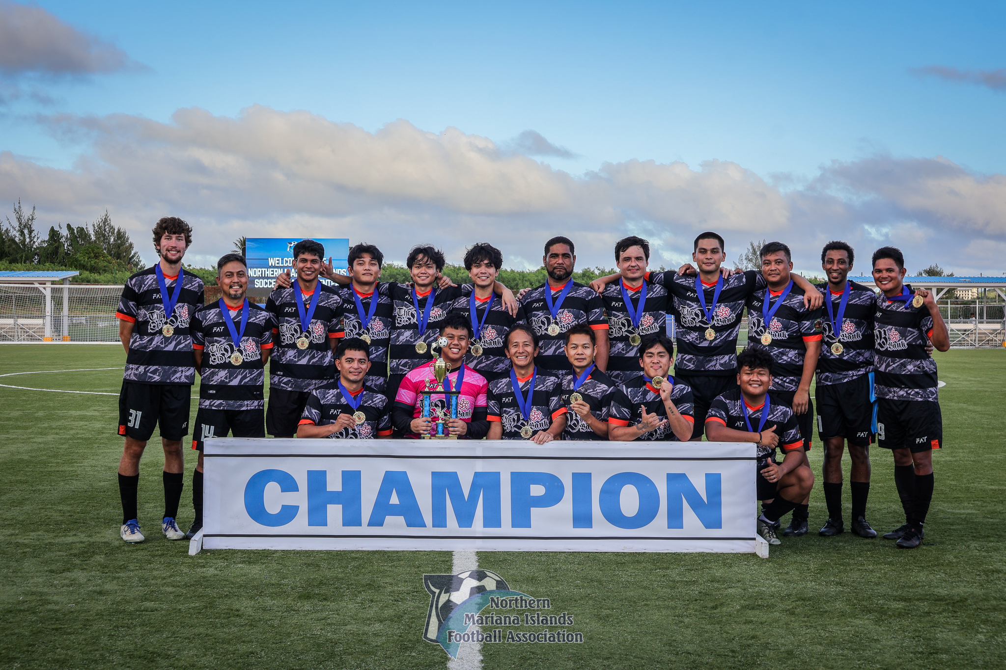 Old B Bank players pose with the championship trophy of the Marianas Soccer League 2 after defeating the Paire Football Club at the NMI Soccer Training Center in Koblerville on Saturday