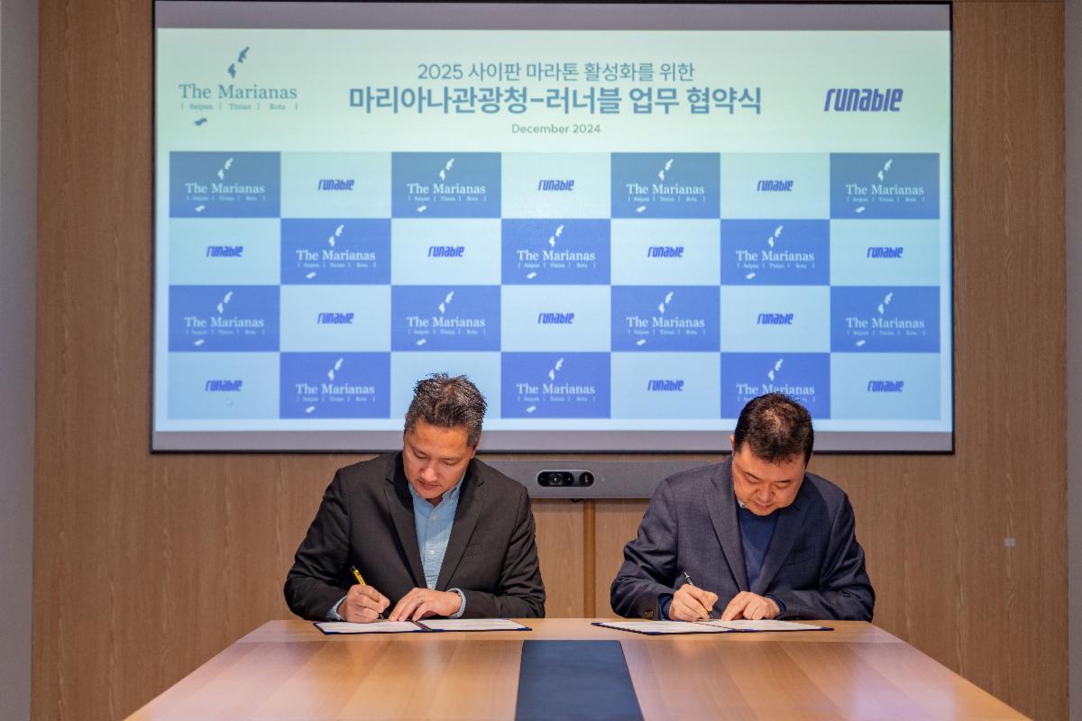 Marianas Visitors Authority Managing Director Christopher A. Concepcion, left, and RUNABLE CEO Young-ho Ryu sign an MOU on Dec. 11, 2024, to promote the Saipan Marathon set for March 8, 2025 in Saipan.