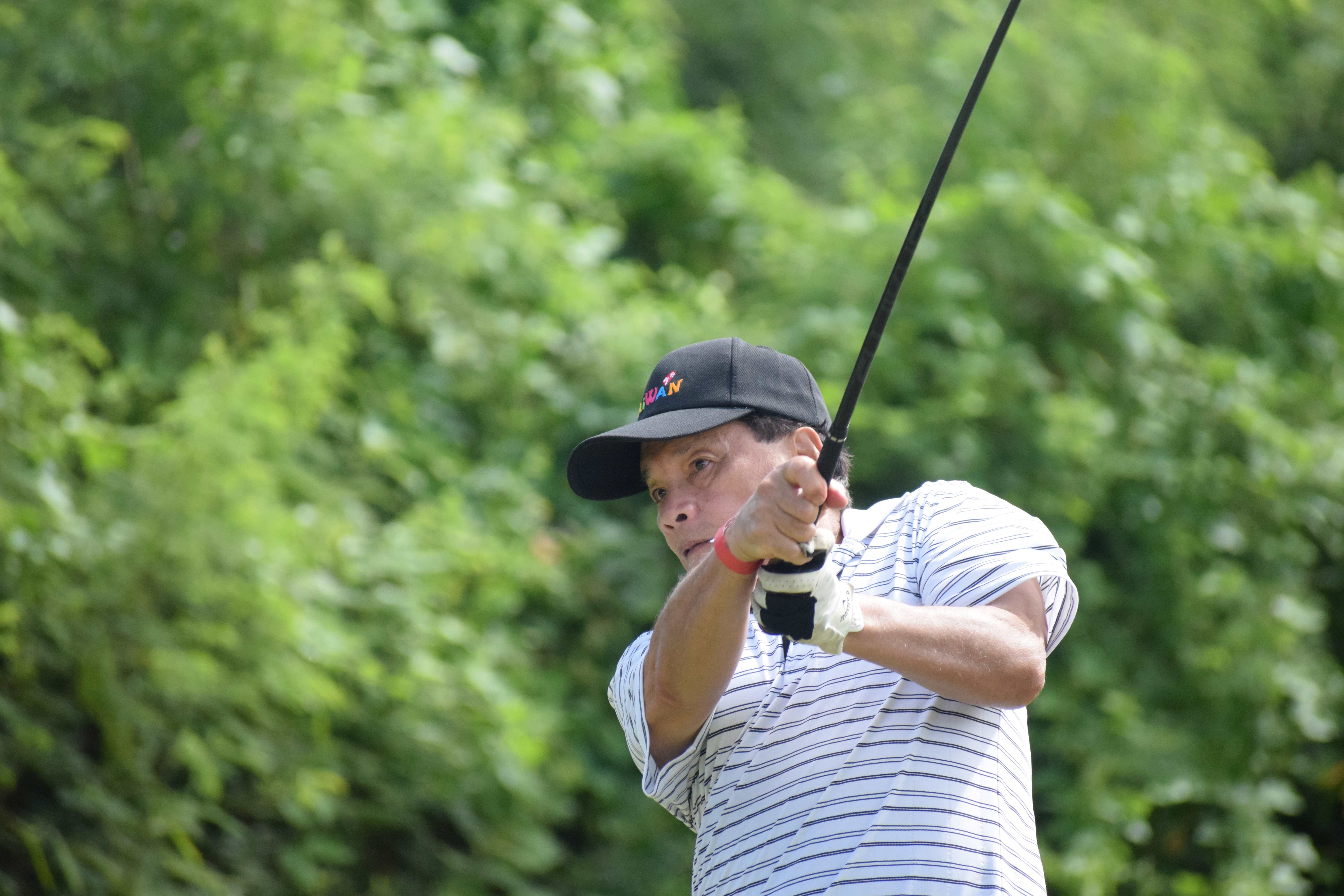 Former Rep. John S. Reyes hits the ball on the par-4 Hole No. 16.