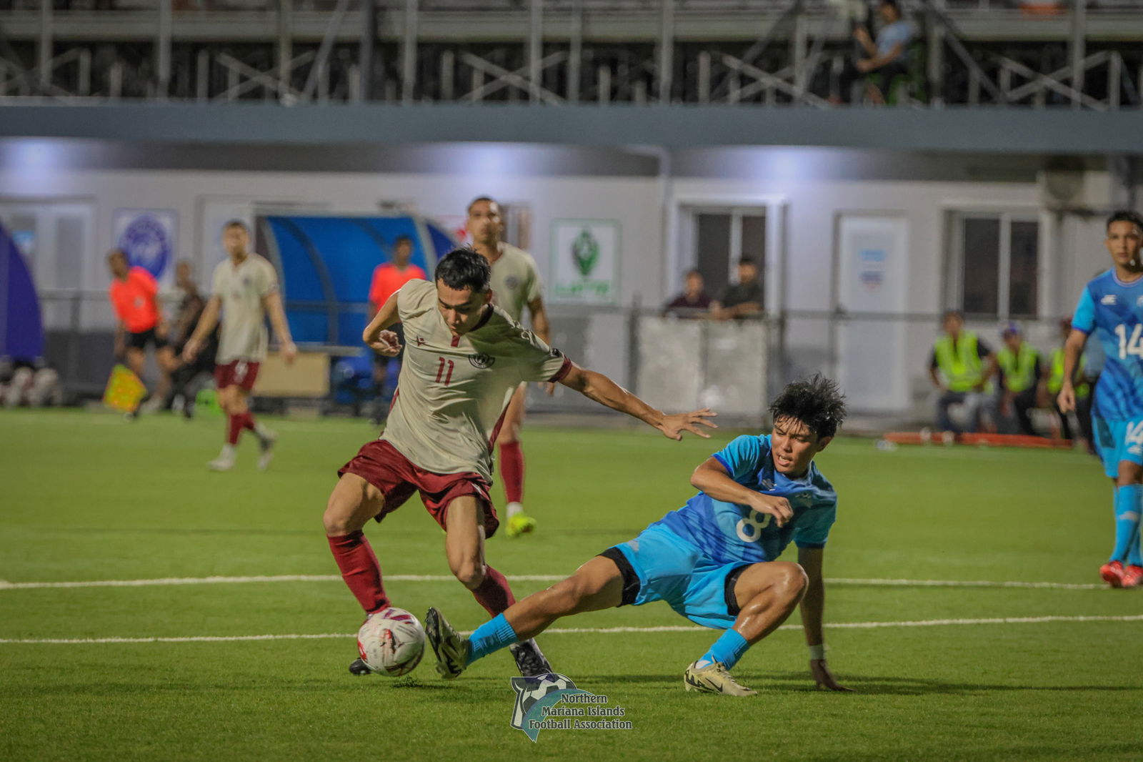 The NMI's Paul Lizama slides in an attempt to intercept the possession against Guam during the first game of the Marianas Friendlies at the NMI Soccer Training Center in Koblerville on Saturday. 