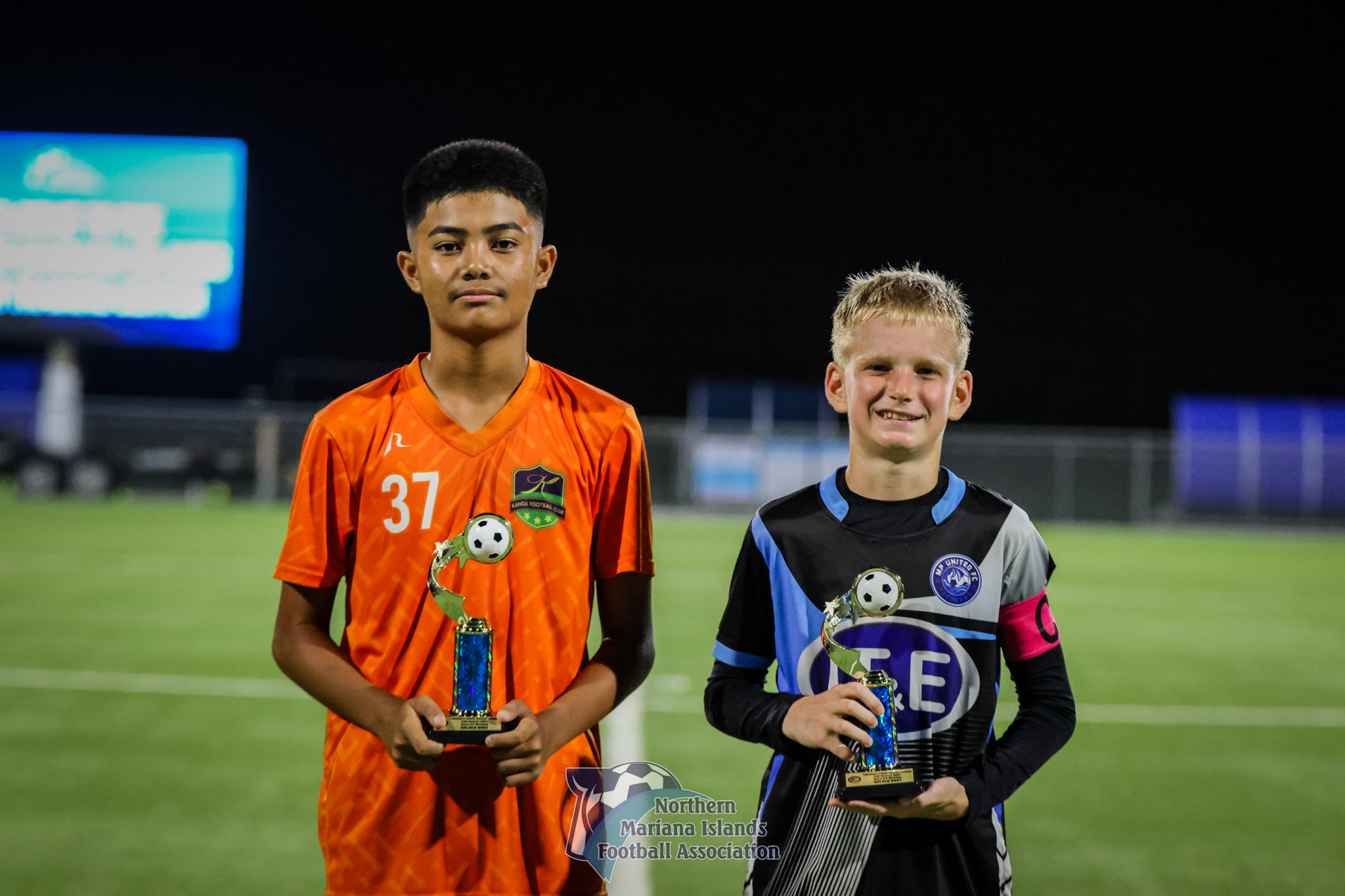 U12 boys division’s Golden Boot winners Aldric Antonio of Kanoa Football Club and Quido Jambor of MP United Football Club pose for a photo during the awards ceremony of the TakeCare Youth Soccer League Fall 2024  at the NMI Soccer Training Center in Koblerville on Saturday.