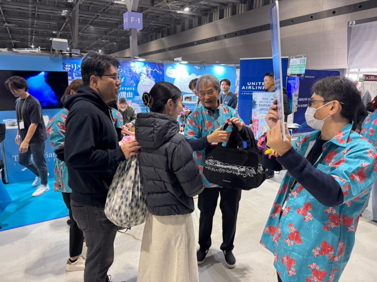 Attendees of the Toyota Group Thanks Sale on Dec. 7 & 8, 2024, in Nagoya, Japan, engage with the Marianas Visitors Authority at The Marianas booth. MVA, Toyota Tsusho, Toyota Tourist and AK Toyota promote attractions in The Marianas at the trade show.