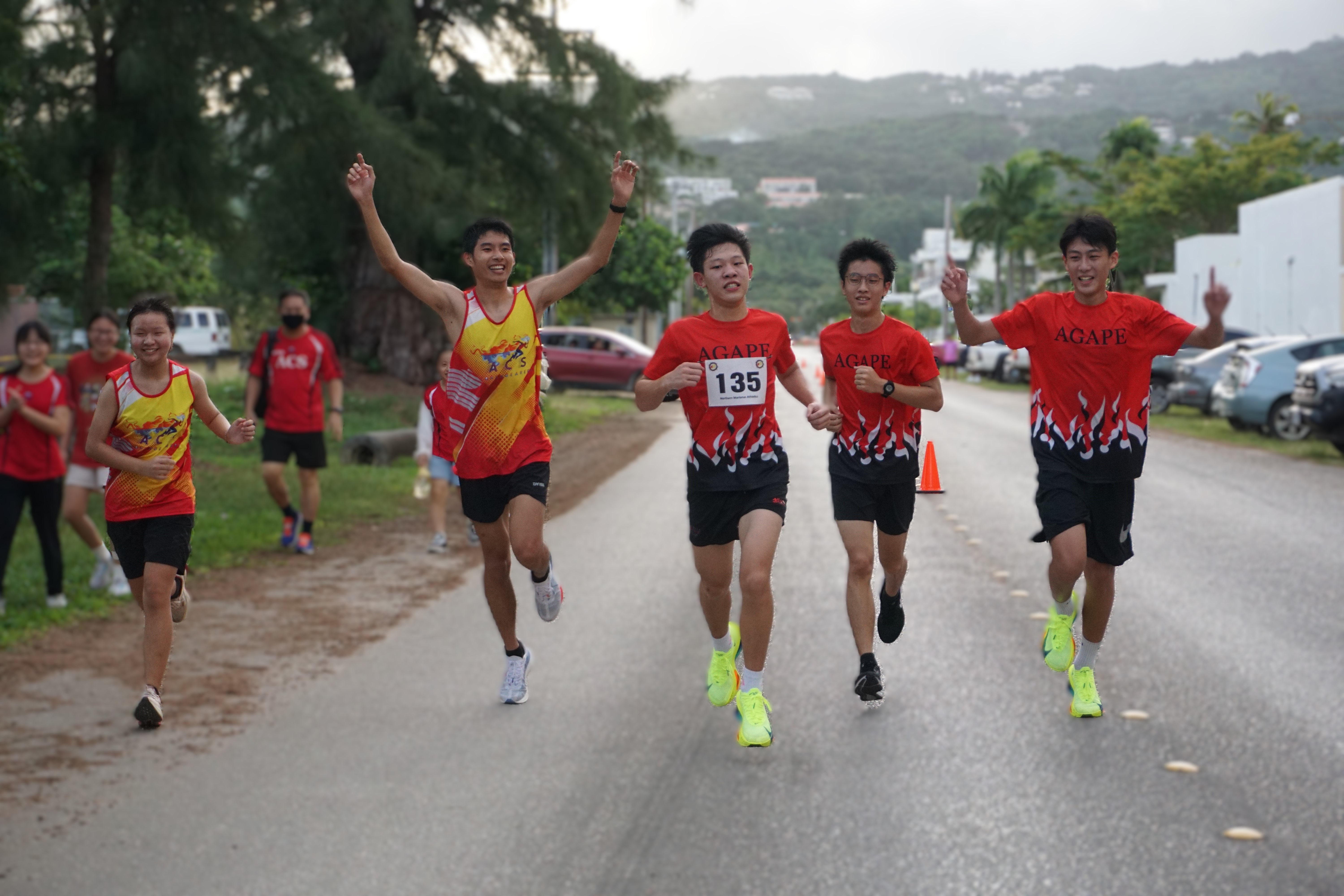 Agape Team 1 members celebrate as they cross the finish line in the open division of Northern Marianas Athletics’ 43rd Annual Christmas Island Relay 2024 in the Marianas Beach Resort/Micro Beach area on Saturday morning.