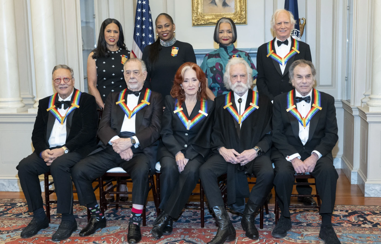 Front row, from left, 2024 Kennedy Center Honorees Arturo Sandoval, Francis Ford Coppola, Bonnie Raitt, Bobby Weir, Mickey Hart; second row, from left, Michelle Ebanks, Kamilah Forbes, Jonelle Procope and Billy Kreutzmann pose for a photo at the State Department for the Kennedy Center Honors Dinner, Saturday, Dec. 7, 2024, in Washington, D.C.
