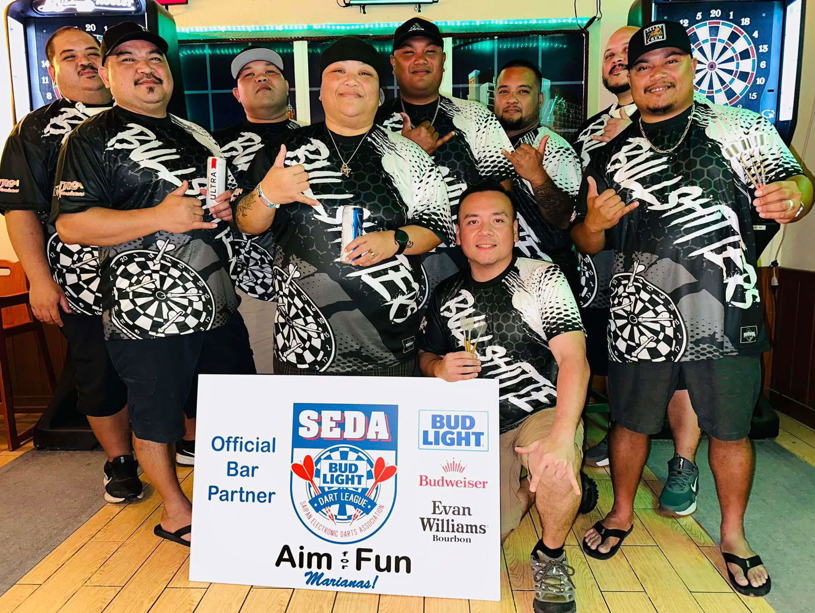 The Bistro SIA BullsHitters pose for a group photo after defeating the 9Eleven Bud Kings to claim the Inter-Government Division title of the 2024 SEDA Bud Light Dart League at the Bistro Marianas on Friday.
