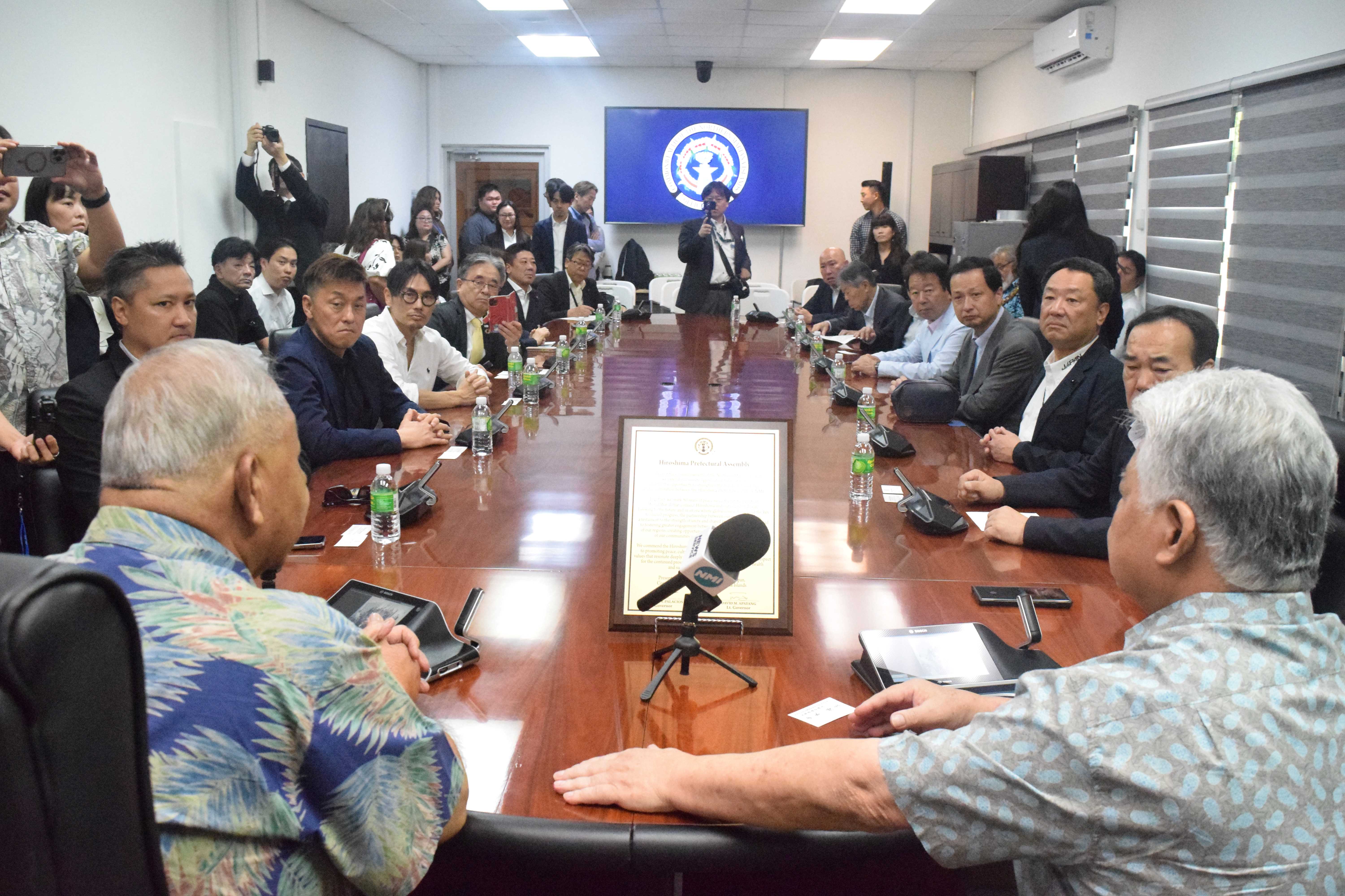 Gov. Arnold I. Palacios, right, addresses the visiting members of the Hiroshima Prefectural Assembly, as Lt. Gov. David M. Apatang, left, listens in the conference room of the governor’s office on Friday.