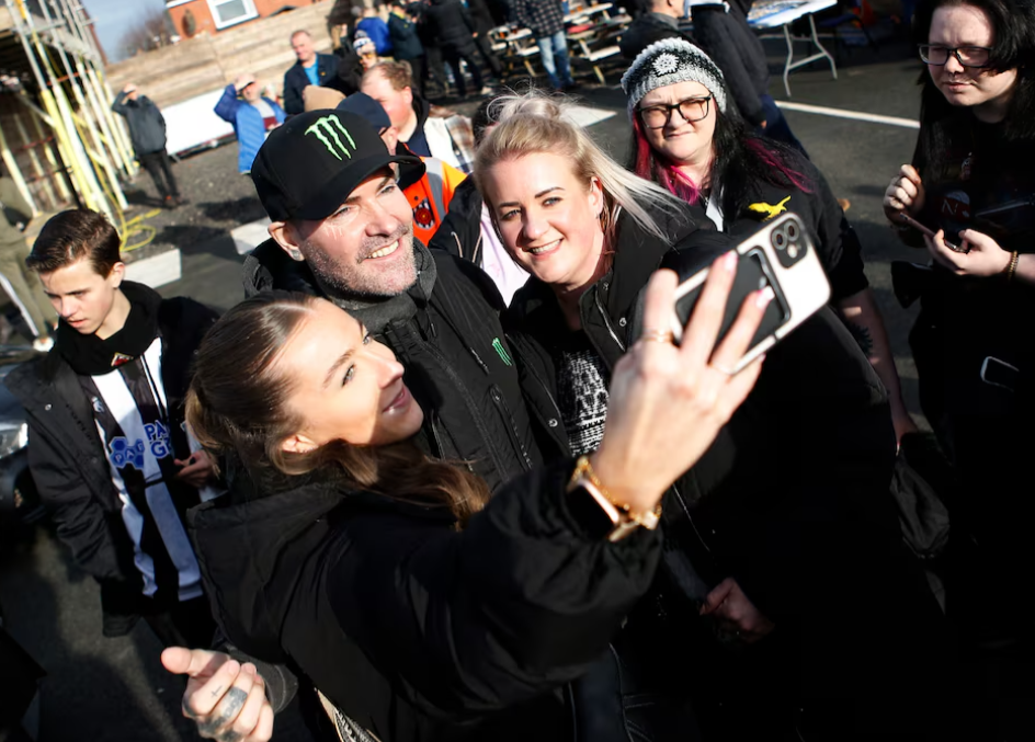 Boyzone member Shane Lynch poses for a selfie with fans before a soccer match at Victory Park in Chorley, Britain, Feb. 10, 2024.