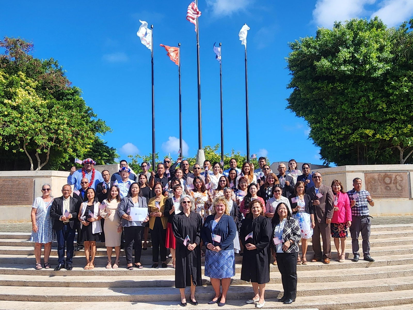 Magistrate Judge Heather Kennedy, U.S. Citizenship and Immigration Services District Director for the Seattle District Office Leanne Leigh, Chief Judge Ramona V. Manglona, USCIS-Guam Supervisor Karena Dulla and USCIS Officer Patricia Phelan pose with the 40 new U.S. citizens at American Memorial Park’s Court of Honor and Flag Circle on Thursday.