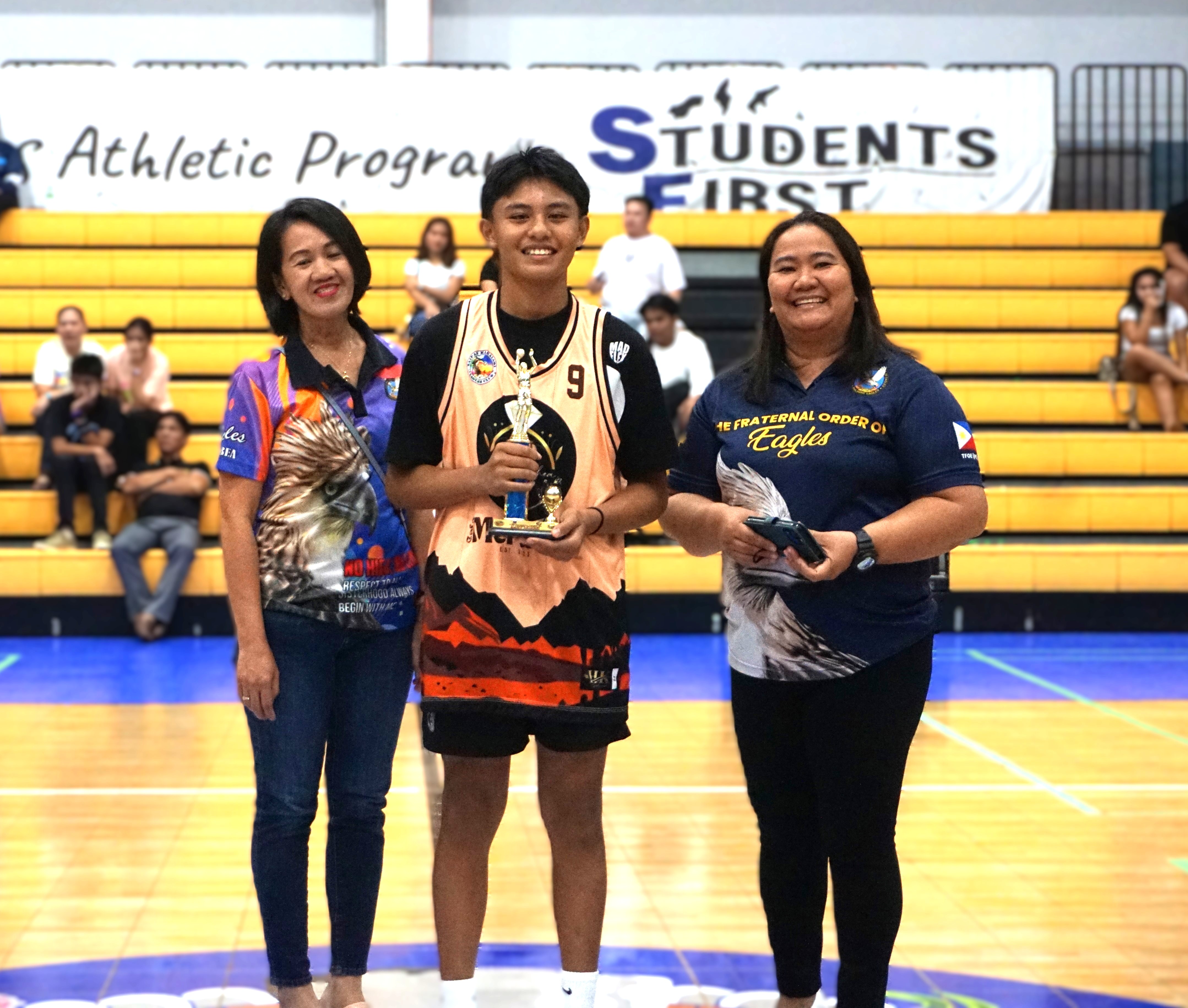 U17 Finals MVP Dane Tibayan poses with SMLEG officials during the awards ceremony of the 2nd SMEC-SMLEG Basketball Tournament at the Ada gym on Sunday.