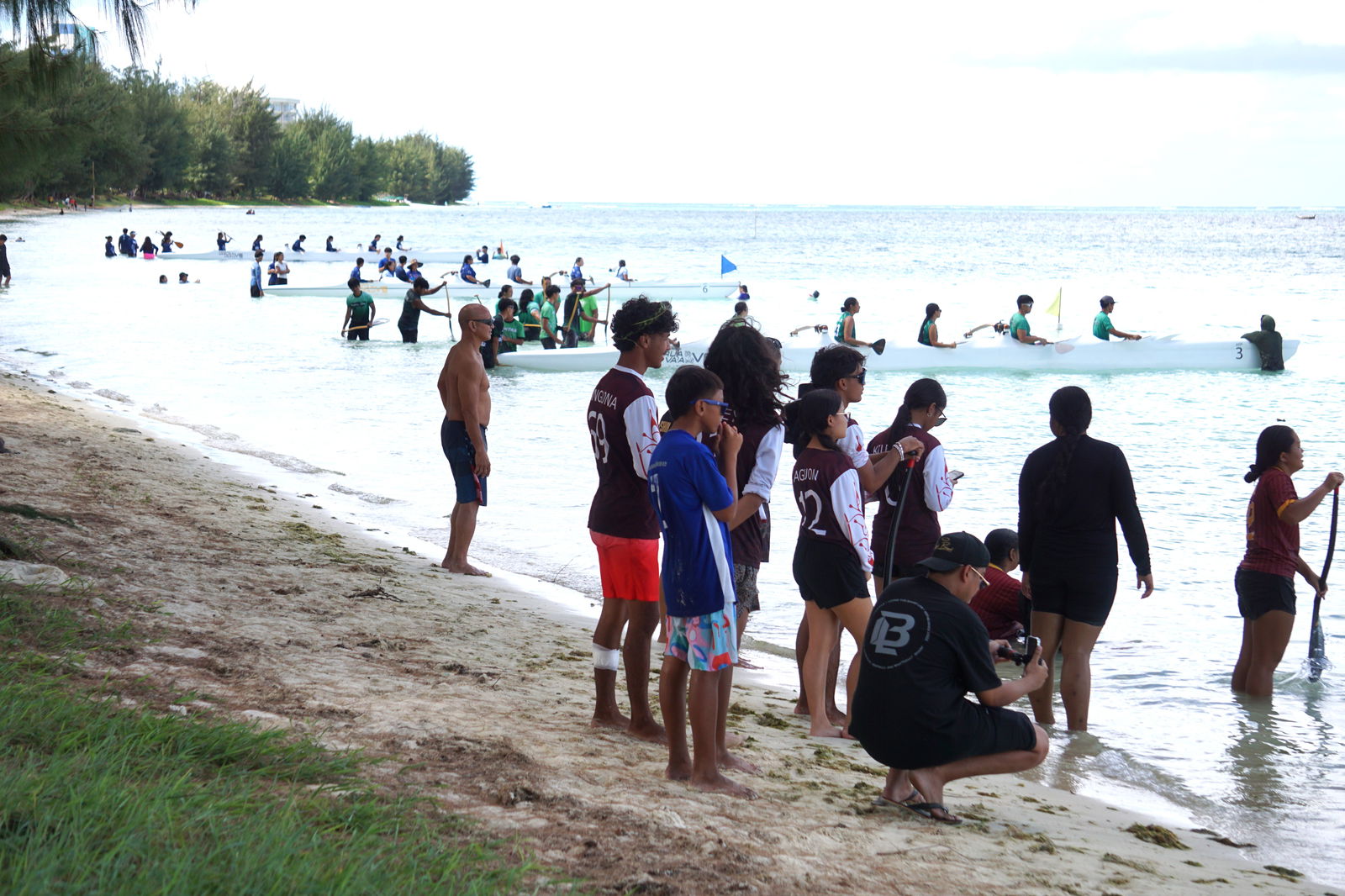 The participating teams prepare for a race during the "no point" opening event of the PSS-NMNPSF Interscholastic Outrigger Race Series SY24-25 on Saturday at Kilili Beach. 
