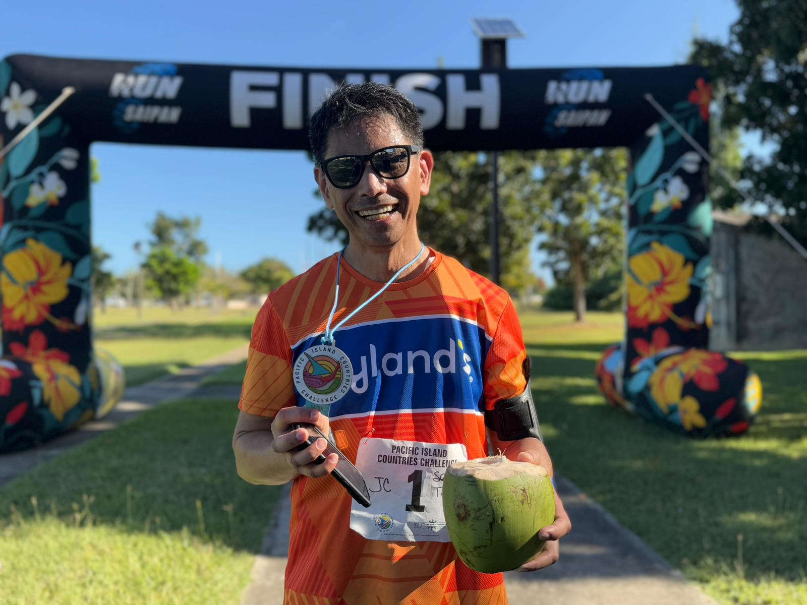 JC Santa Teresa poses with his medal and coconut after completing the marathon.