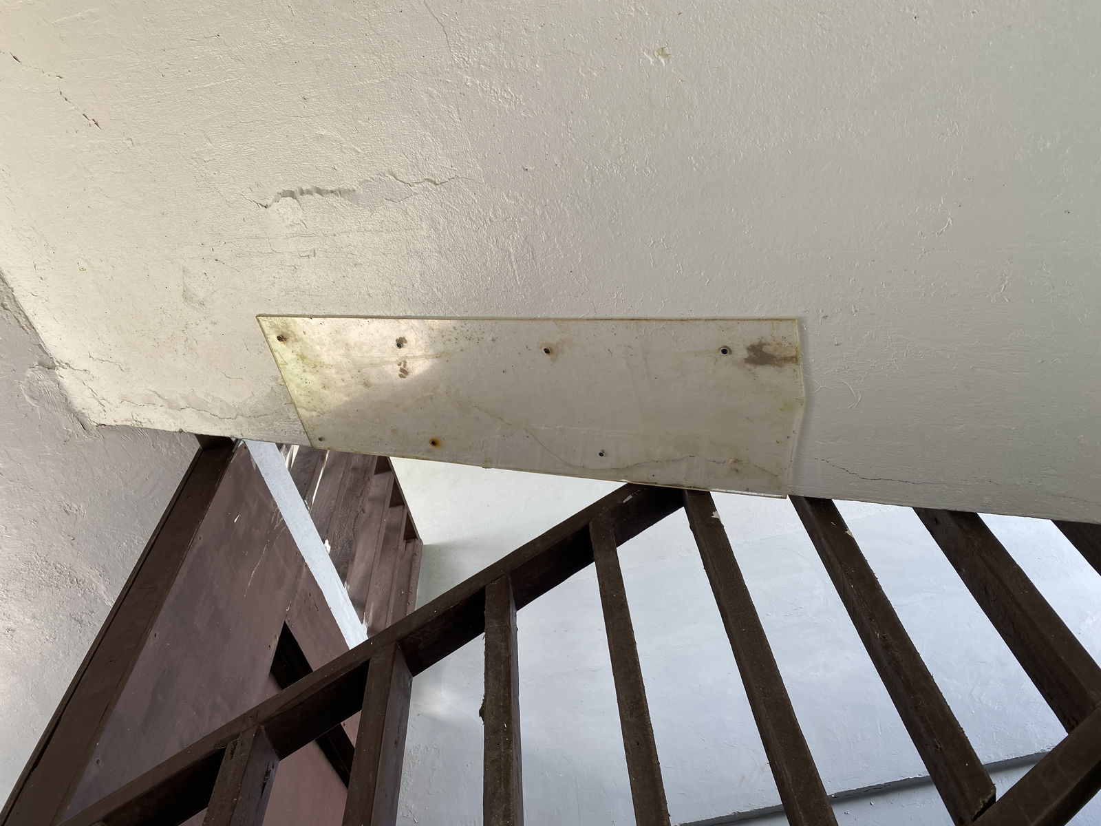Plexiglass covers a crack beneath the stairwell at the CIC building.