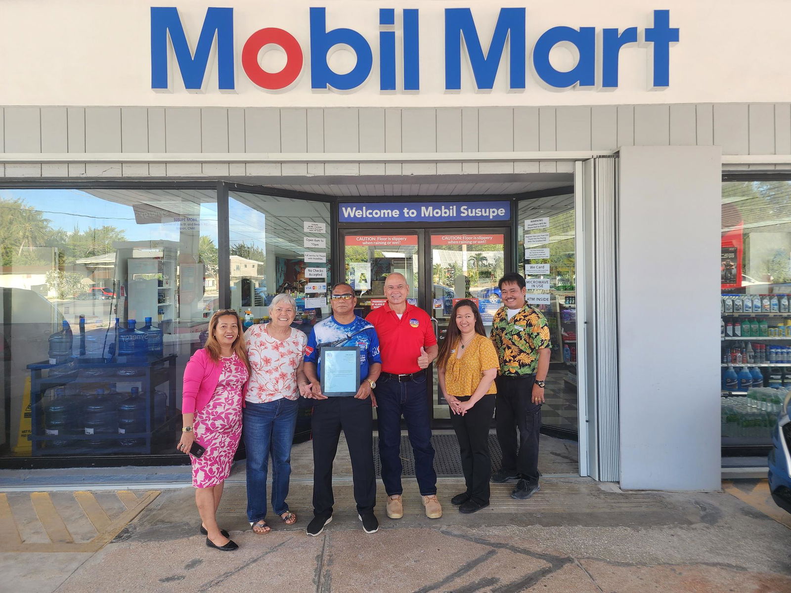 Marcelino “Max” Baleto Aguon, 3rd left, with JEMCO operators Edward and Jovita Flores, and Susupe Mobil Gas Station staffers on Friday.
