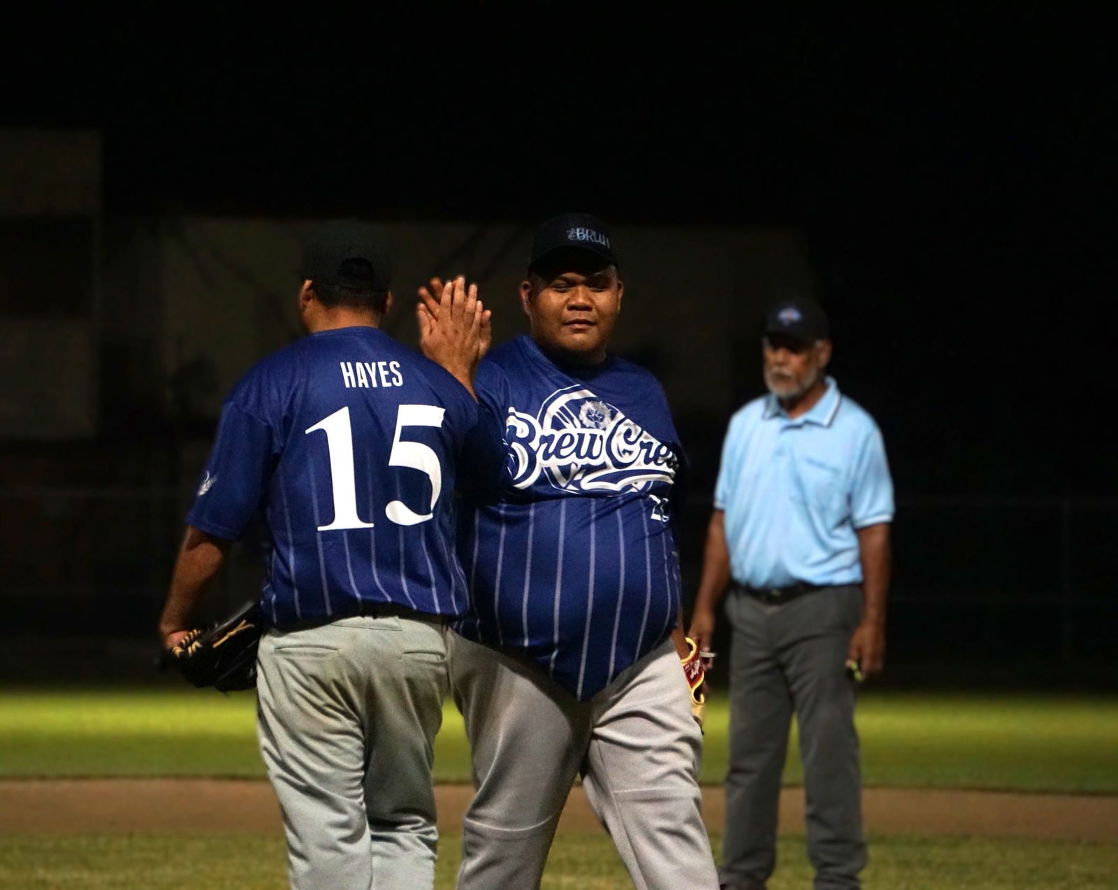 The Brewers’ Dennis Cabrera high-fives relief pitcher Jason Hayes during a game in the 2024 SBL Masters League at the Francisco “Tan Ko” Palacios Baseball Field.
