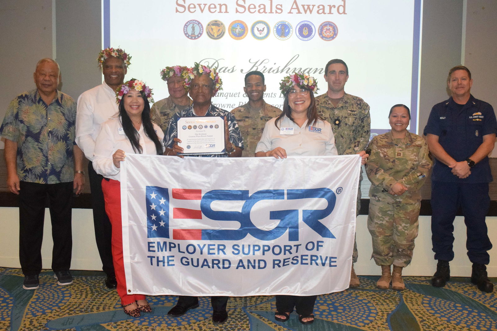 Crowne Plaza Resort Saipan Banquet & Events Director Das Krishnan, center, holds the Seven Seals Award as he poses for  a photo with Employer Support for the Guard and Reserve National Chair John T. Sampa, second left, back row, State Chair Cathy Gogue, right front row, Guam-CNMI Area Chair Joann Aquino, left, front row, Lt. Gov. David M. Apatang, left, adjutant general of Guam’s National Guard Michael Cruz, third left, backrow,  National Guard and Reserve officers.Photo by Emmanuel T. Erediano