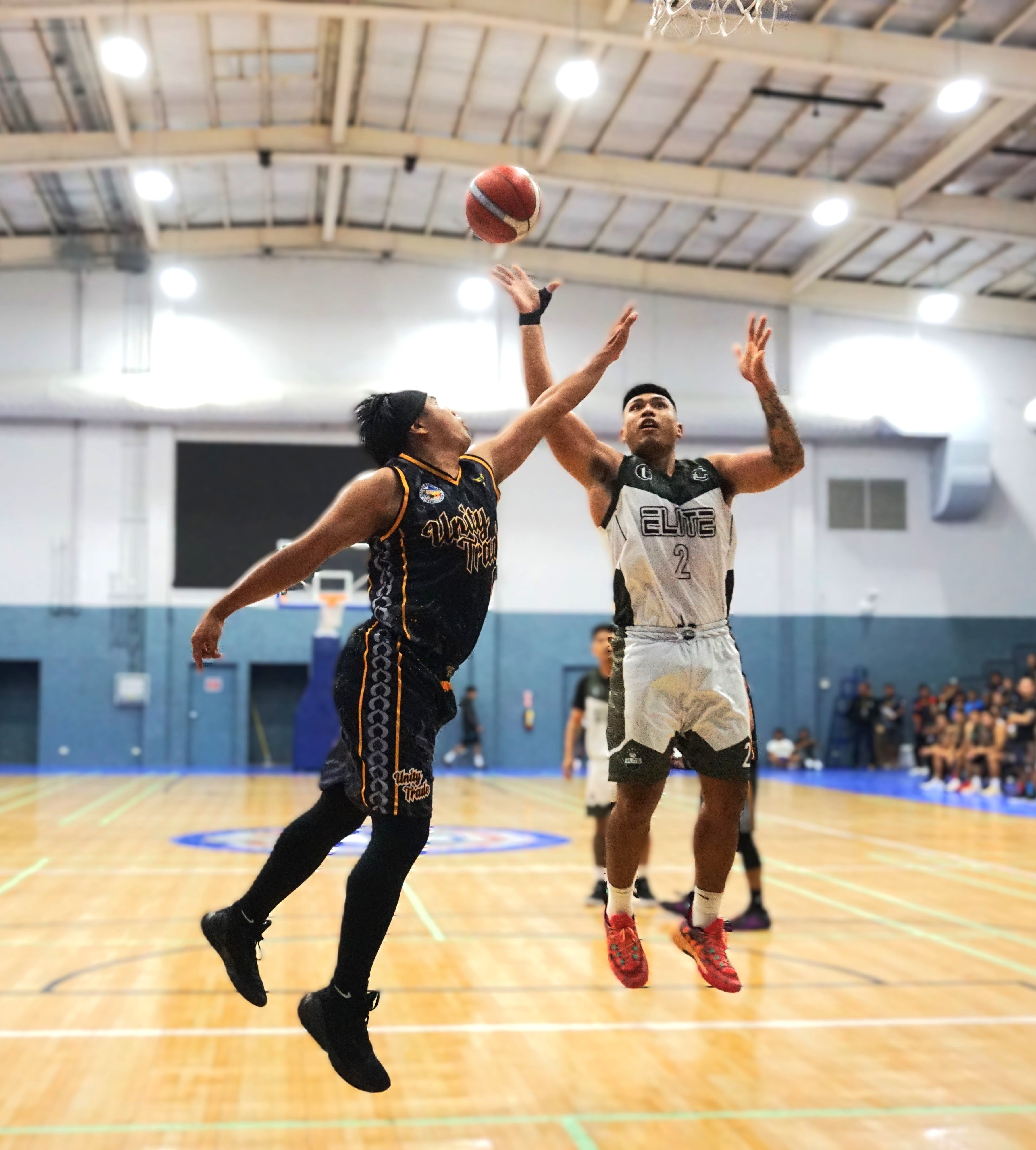 Elite's Mi'i Tekopua attempts a floater over Unity Trade’s Ivan De Vero during the championship game in the open division of the 2nd Saipan Magalahi Eagles Club-Saipan MagaHaga Lady Eagles Group Basketball Tournament at the Ada gym on Sunday night.