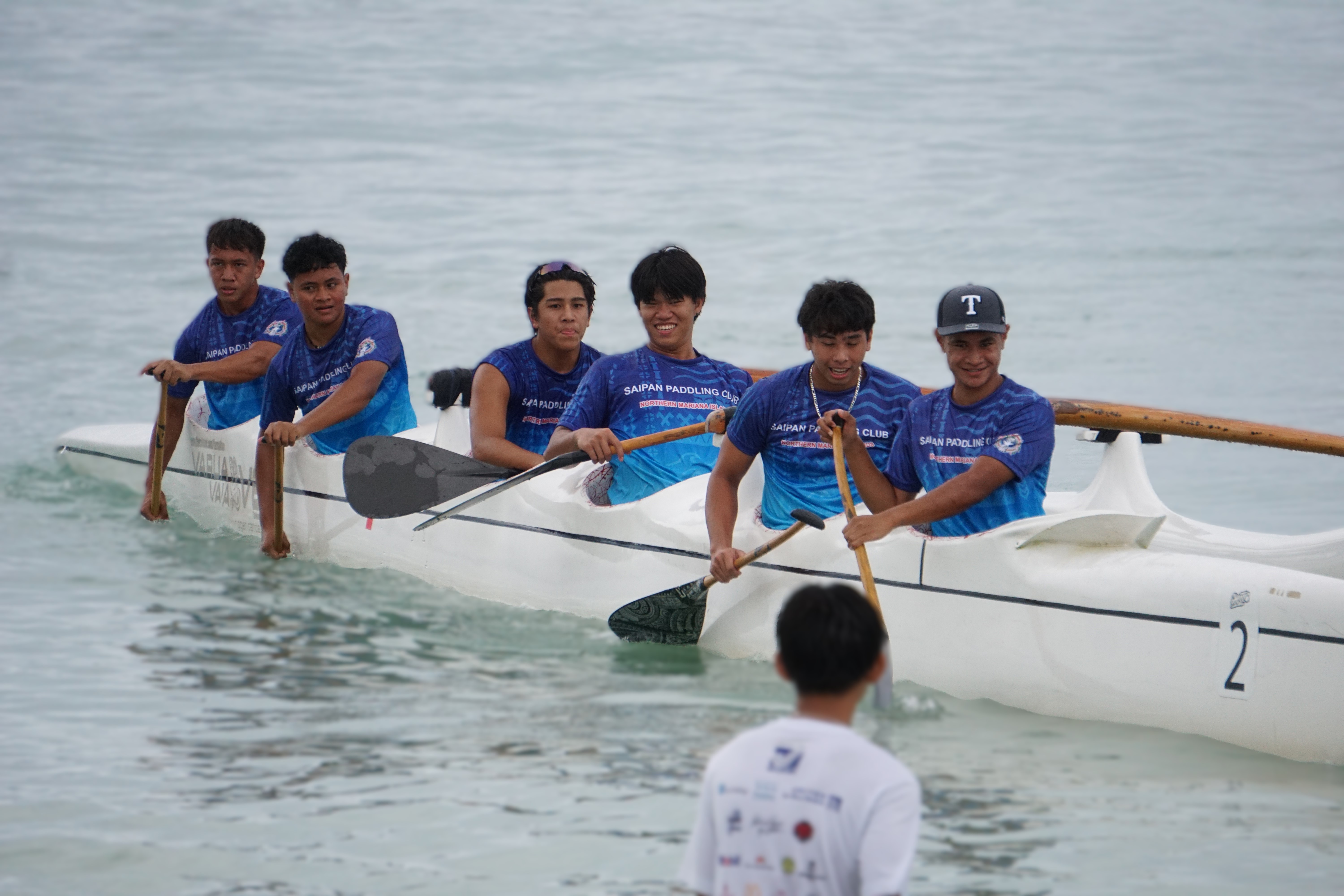Tyler Andrew (wearing a cap) of the Saipan Paddling Club won gold in the junior men’s V1 500m race at the 24th Micronesian Cup Canoe Race, held at the Crowne Plaza Resort Saipan beach.