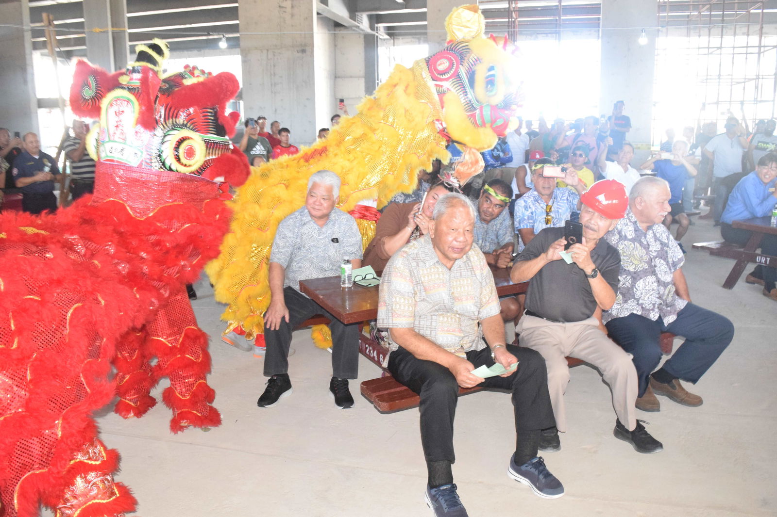 Chinese community members perform the dragon dance during the Lunar New Year celebration at the construction site of the future Marriot Hotel operated by Honest Profit International in San Antonio. Also in photo are Gov. Arnold I. Palacios, Lt. Gov. David M. Apatang, Labor Secretary Leila Staffler, Rep. Roman C. Benavente, right, and local architect Herman Cabrera.