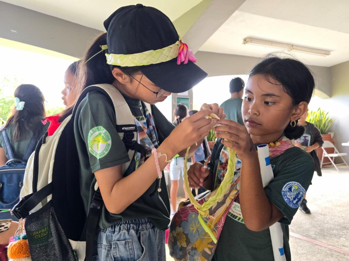 Students explore coconut frond weaving during the Marianas Tourism Education Council Tourism Summit on Jan. 24, 2025, at Garapan Central Park in Saipan.