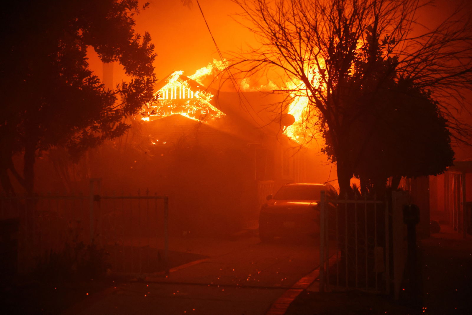 A house burns as powerful winds fueling devastating wildfires in the Los Angeles area force people to evacuate, at the Eaton Fire in Altadena, California, Jan. 8, 2025.