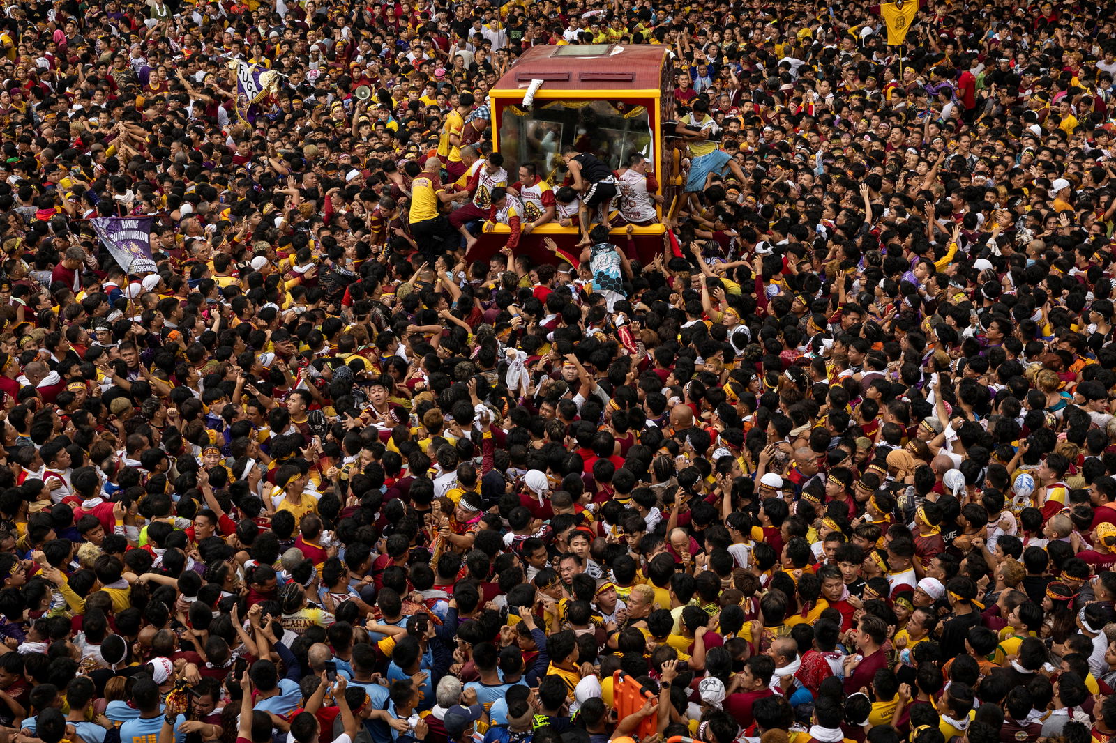 Filipino Catholic devotees jostle to touch the carriage carrying the statue of the Black Nazarene during the annual procession on its feast day in Manila, January 9, 2025. 