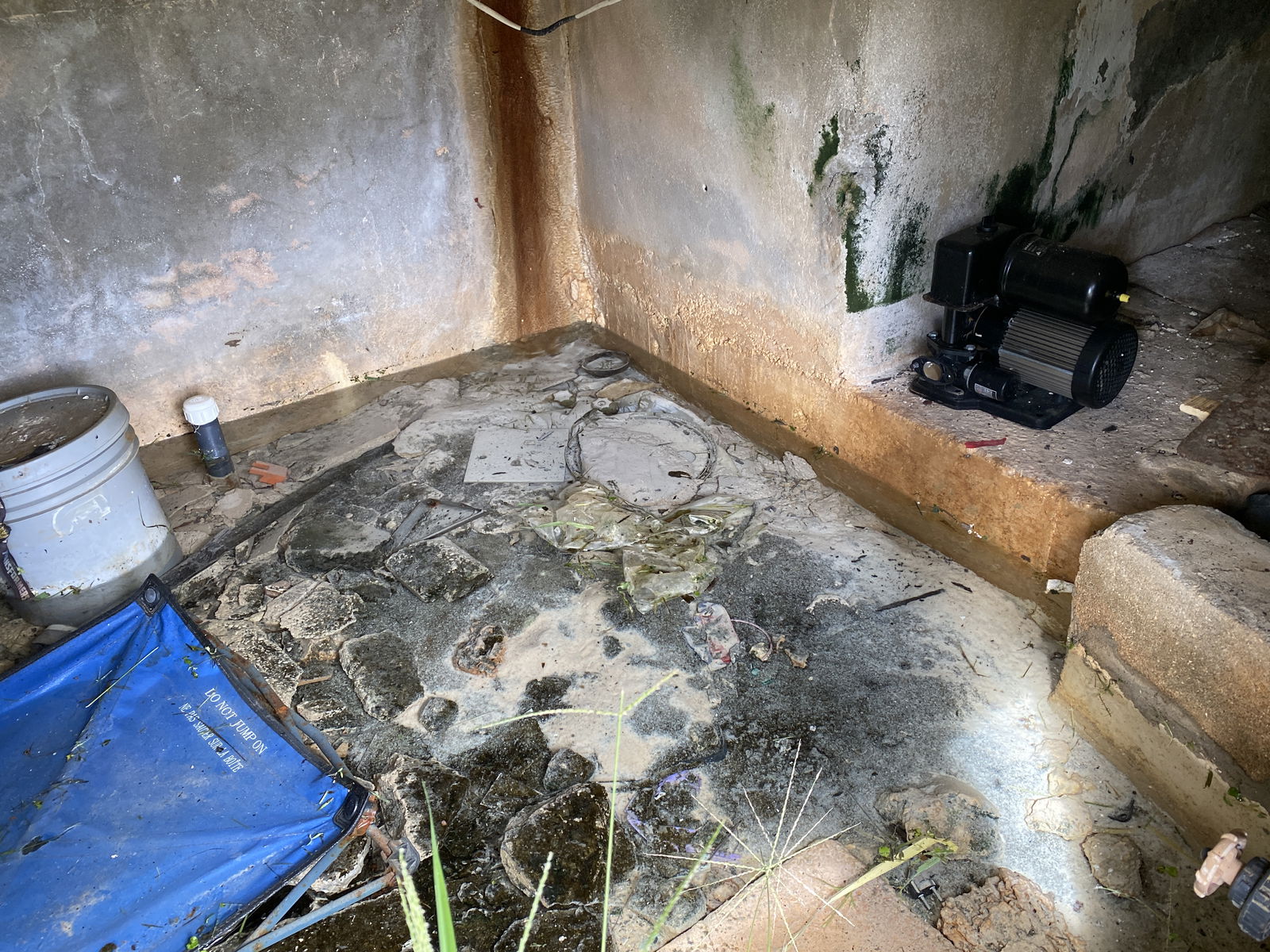 While Daniel Durkin experiences low water pressure in his apartment on the third floor, this pool of water and a leak from the wall are seen at the CIC building.