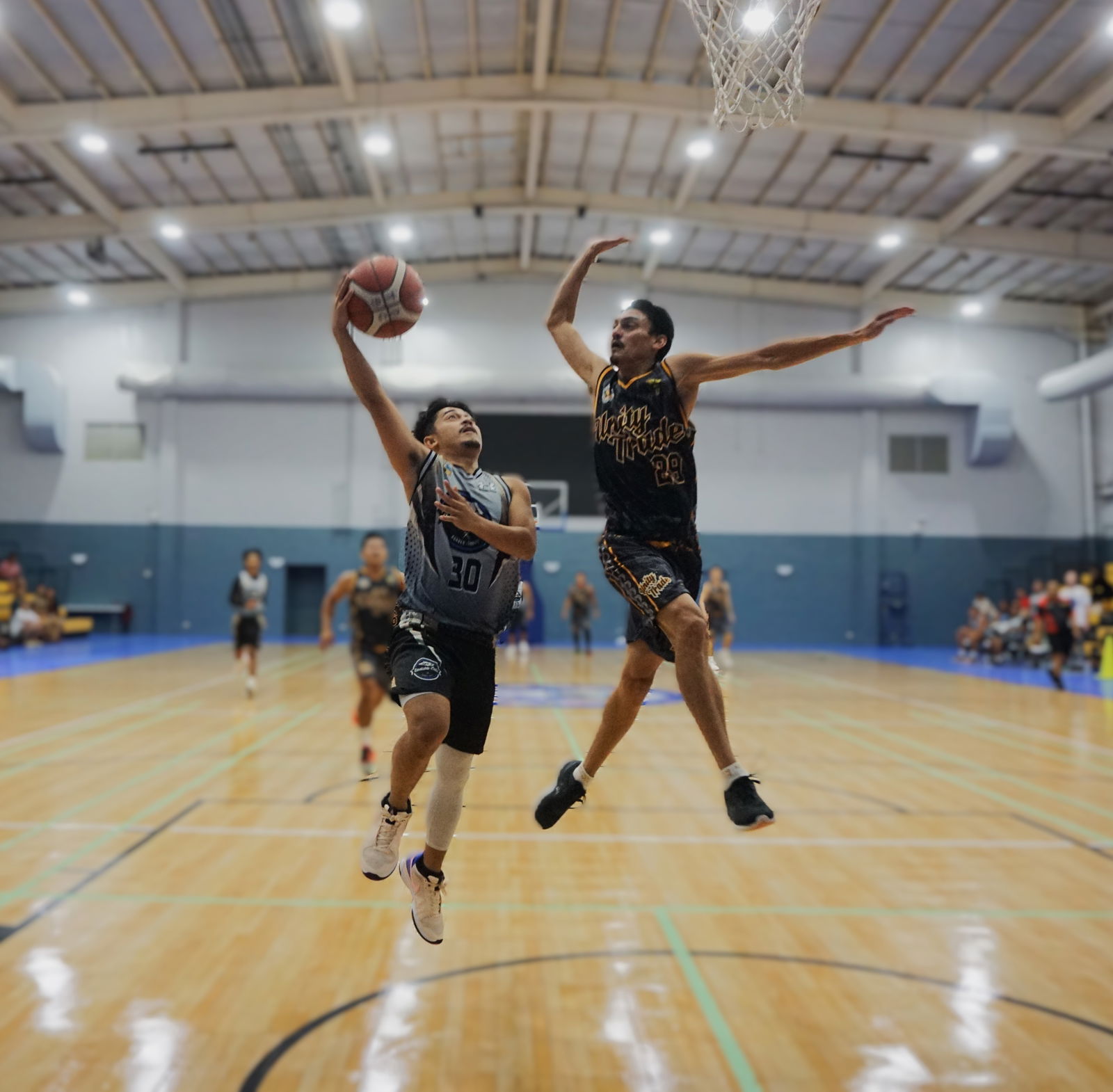 Unity Trade’s Douglas Schmidt contests the shot of East Side Cuts/Saipan Fresh Market’s Jayart Palmes during an open division semifinal game of the 2nd Saipan Magalahi Eagles Club-Saipan MagaHaga Lady Eagles Group Basketball Tournament at the Ada gym on Saturday.