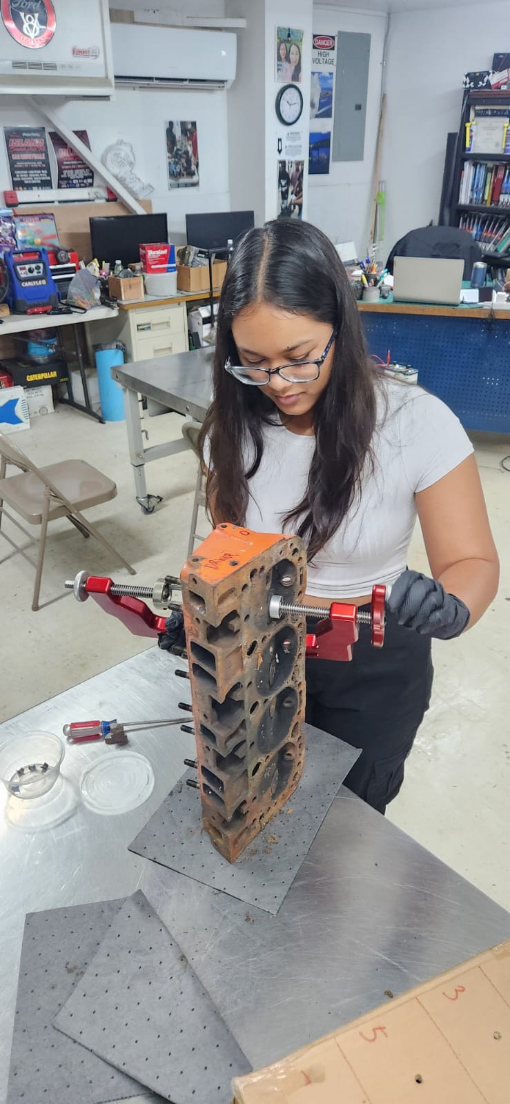 Aubriana Sablan works on a piston housing at the Northern Marianas Technical Institute.