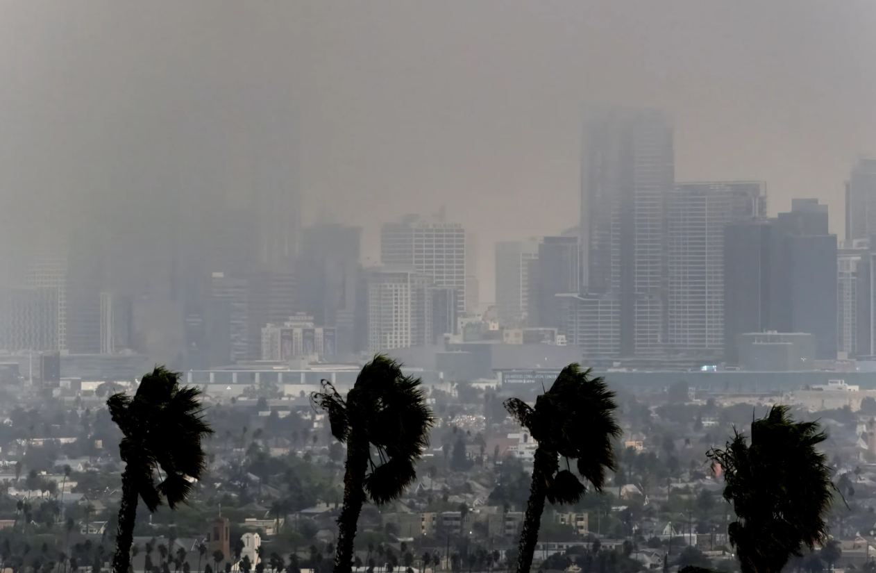 High winds blow as thick smoke from wildfires shrouds downtown Los Angeles on Wednesday, Jan. 8, 2025.