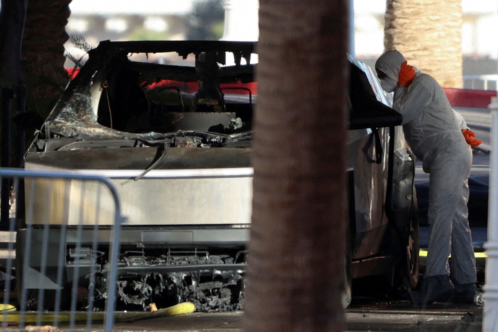 The remains of a Tesla Cybertruck that burned at the entrance of Trump Tower are inspected in Las Vegas, Nevada, Jan. 1, 2025.