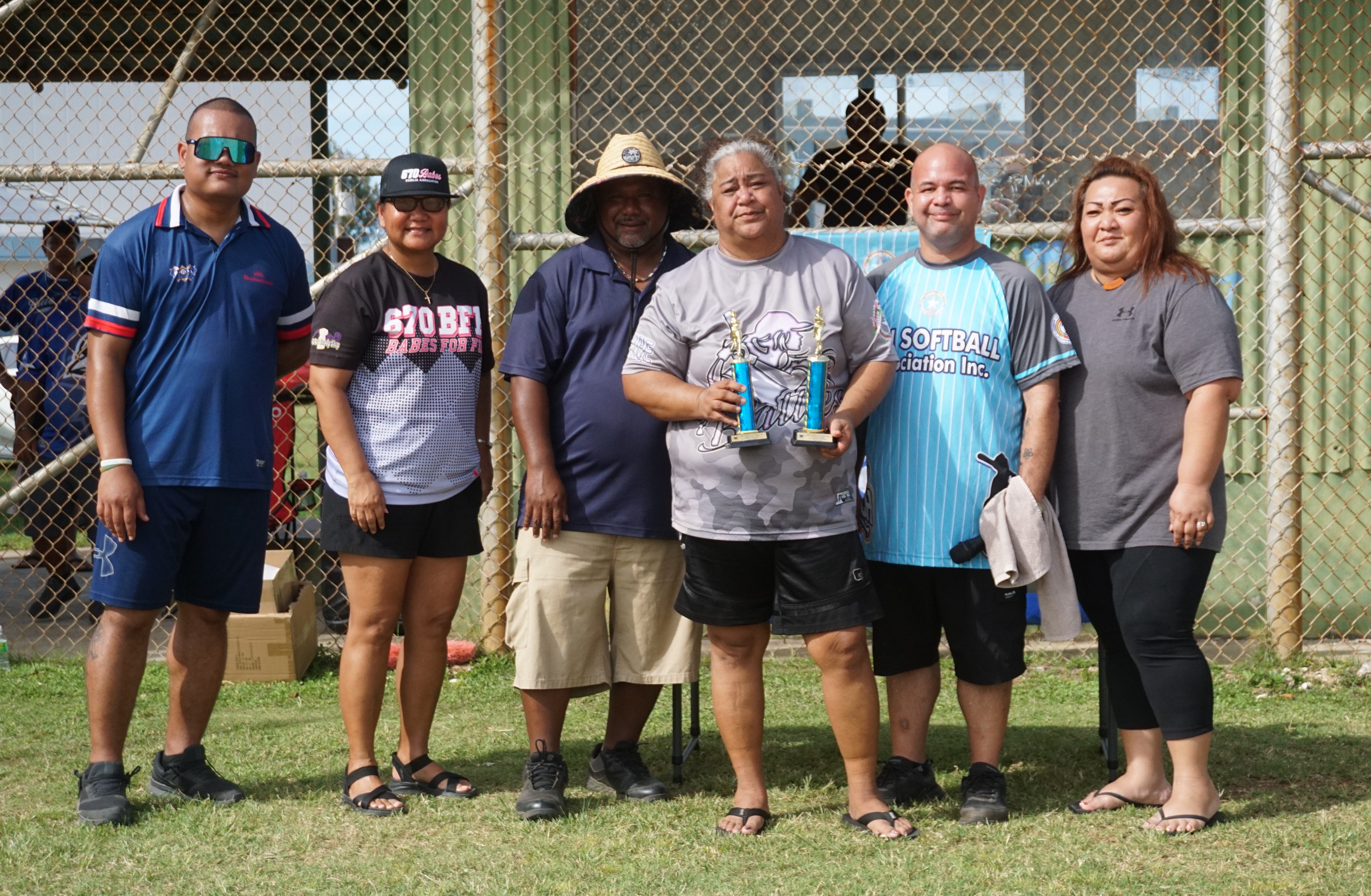 Pitching Leader and Most Strikeouts awardee Jovie Omar of the Batties poses with her trophies alongside NMI Softball Association board members during the awards ceremony of the NMISA Women's Softball League 2024 at the Miguel “Tan Ge” Pangelinan Softball Field on Saturday.