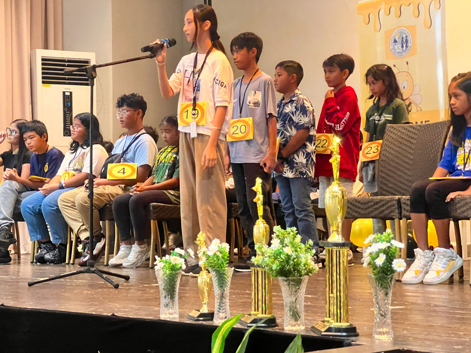 Students from public and private schools take turns competing in the various rounds of the Spelling Bee.