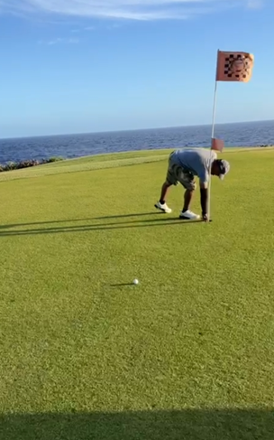 Rafael Demapan picks up his lucky golf ball