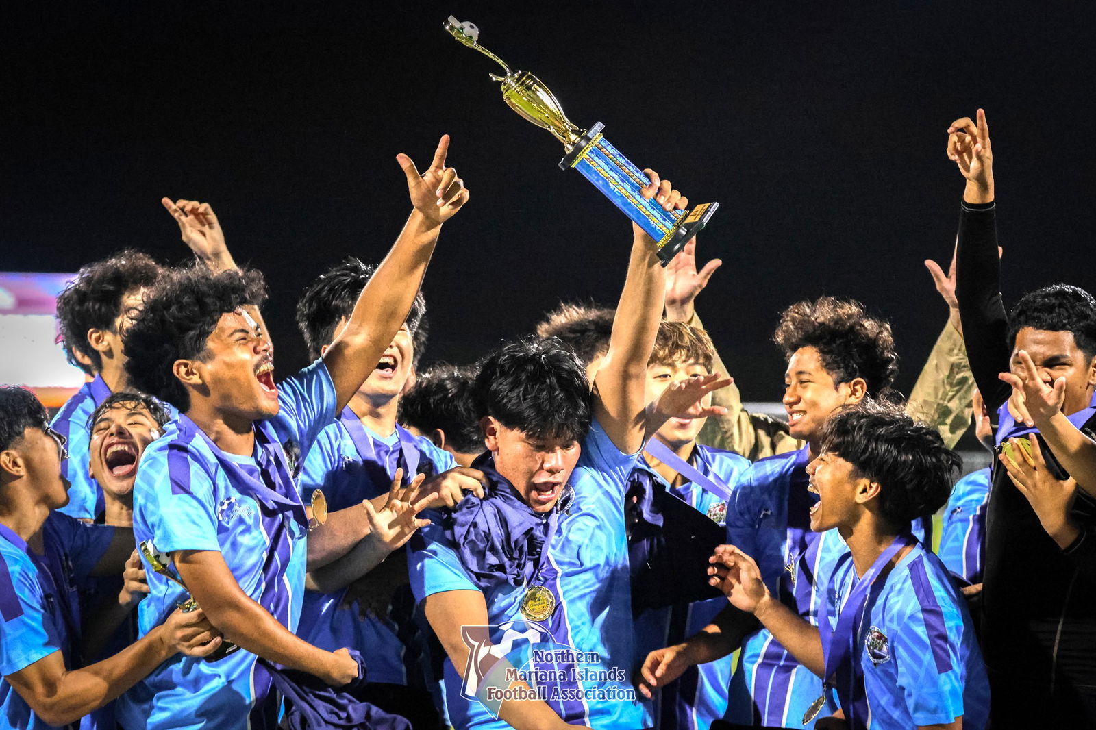 Marianas High School’s varsity team players celebrate after being handed the championship trophy in the boys high school division of the PSS-NMIFA Interscholastic Soccer League SY4-25 at the NMI Soccer Training Center in Koblerville on Thursday.