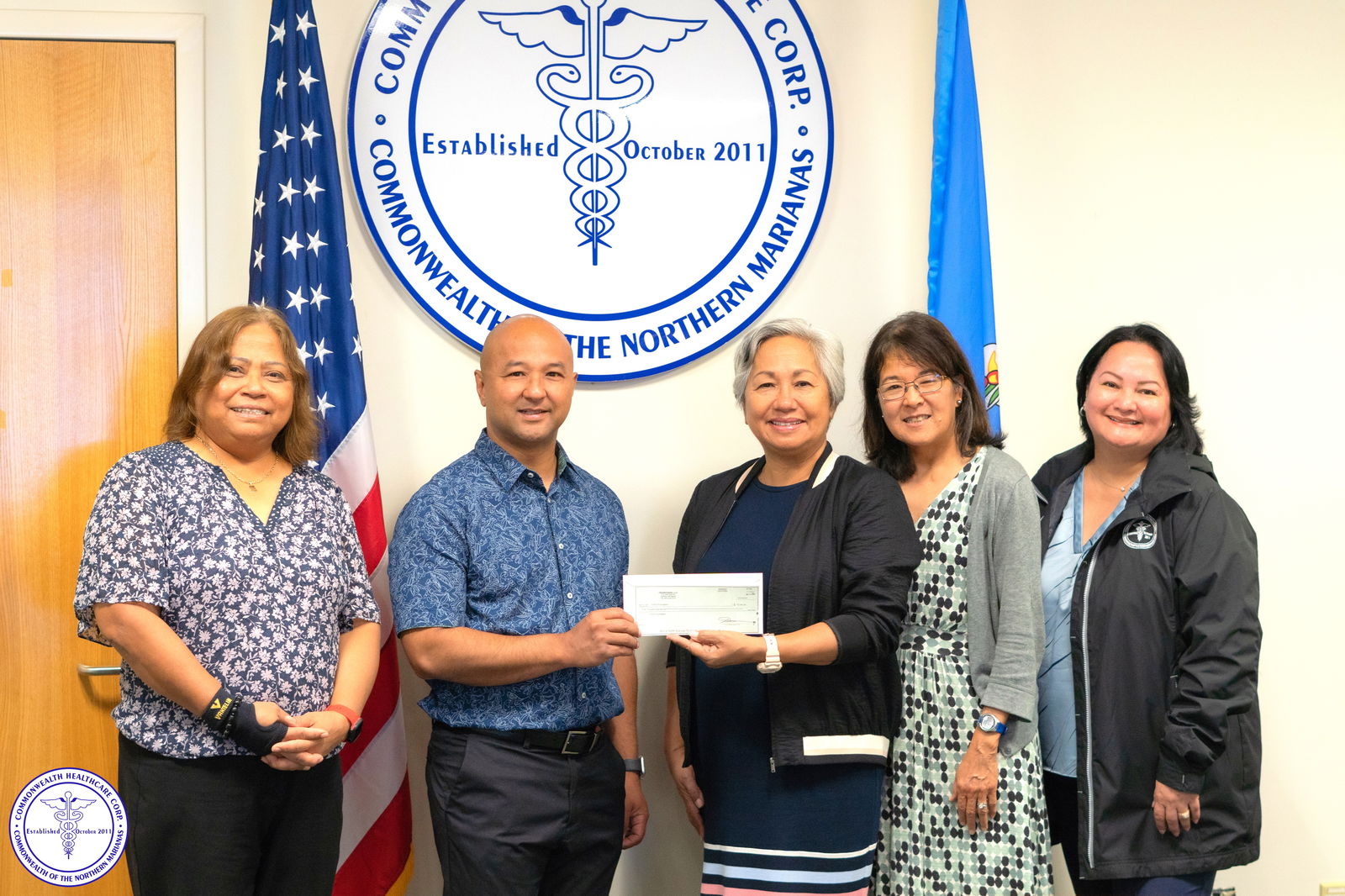 Joe Guerrero, co-owner of Transcends, LLC dba Naked Fish Bar & Grill, presents a check for $5,000 to the CHCC Foundation.