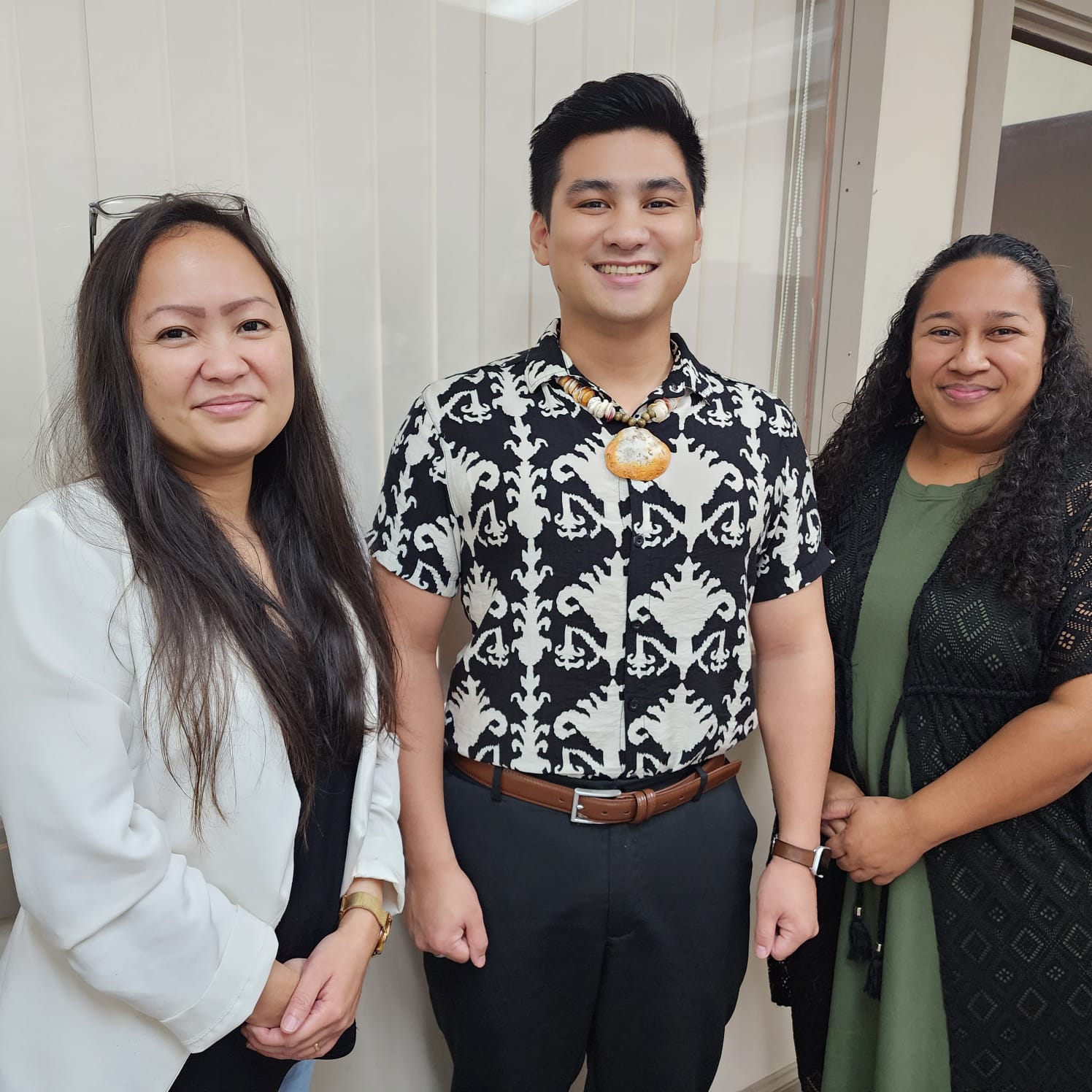Registrar of Corporations John David A. Reyes, center, poses with staff members Tershias Tenorio-Tesero, left, and Jovan Fred at the Department of Commerce on Capital Hill.
