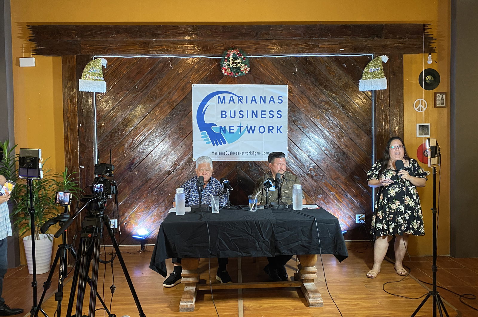 Gov. Arnold Palacios, left, sits next to the event moderator, outgoing House Floor Leader Edwin Propst, at the Marianas Business Network dialogue at the 360 Beach Club in Susupe on Friday.