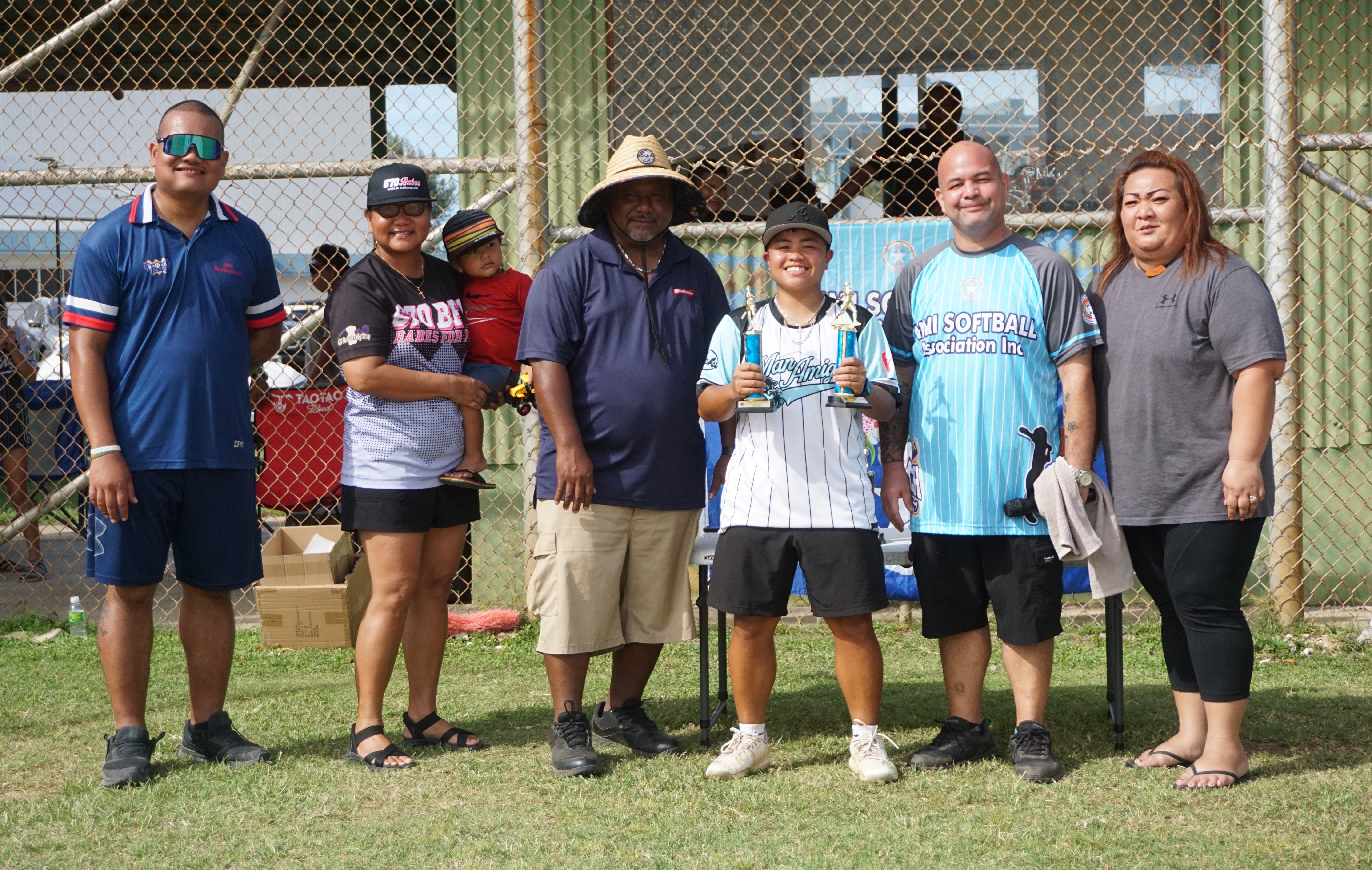 Multi-award winner Kianu Aldan of the Man Amigas poses with her trophies alongside the NMI Softball Association board members during the awards ceremony of the NMISA Women's Softball League 2024 at the Miguel “Tan Ge” Pangelinan Softball Field on Saturday.