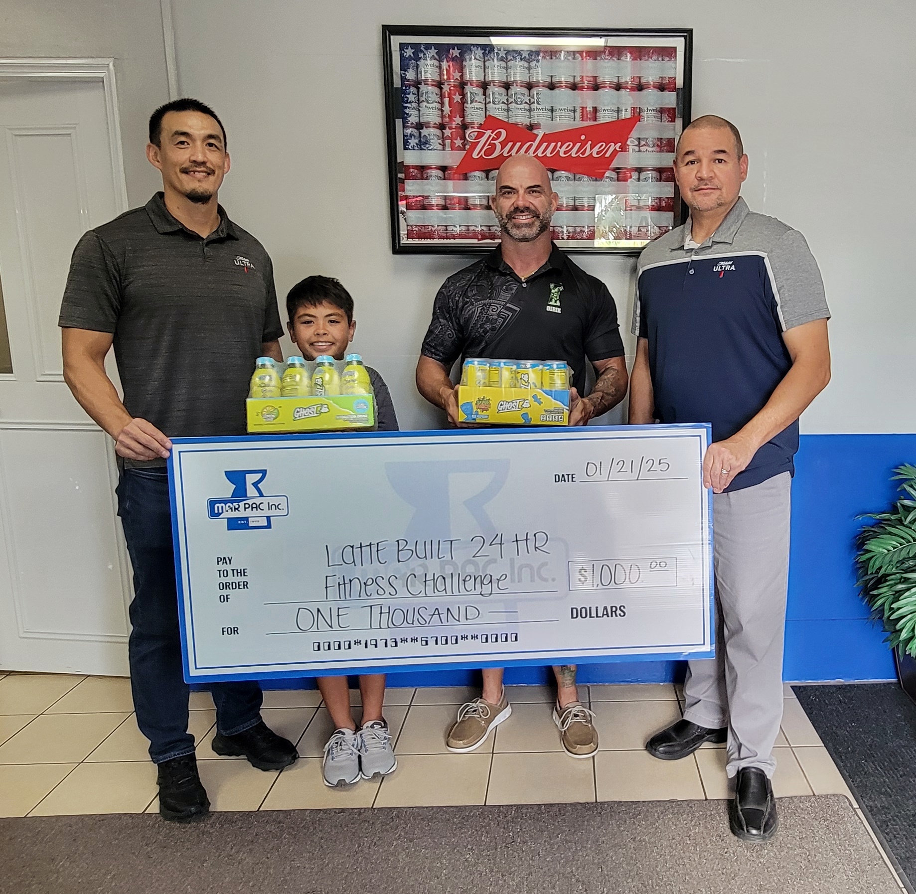 Marpac beverage sales manager James Lee and resident manager Guy Pudney with Latte Built owner Derek Cutting and the $1,000 donation for the pot prize of the 2025 Fat Loss Challenge.