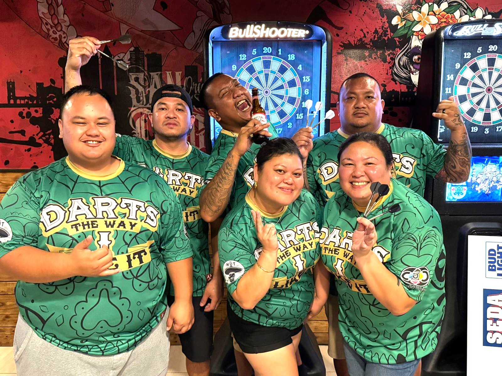 The Hut’s Darts the Way I Like It players pose for a group photo after winning the Flame Tree Thursday B Division Bud Light Cup of the 2024 SEDA Bud Light Dart League at The Hut.