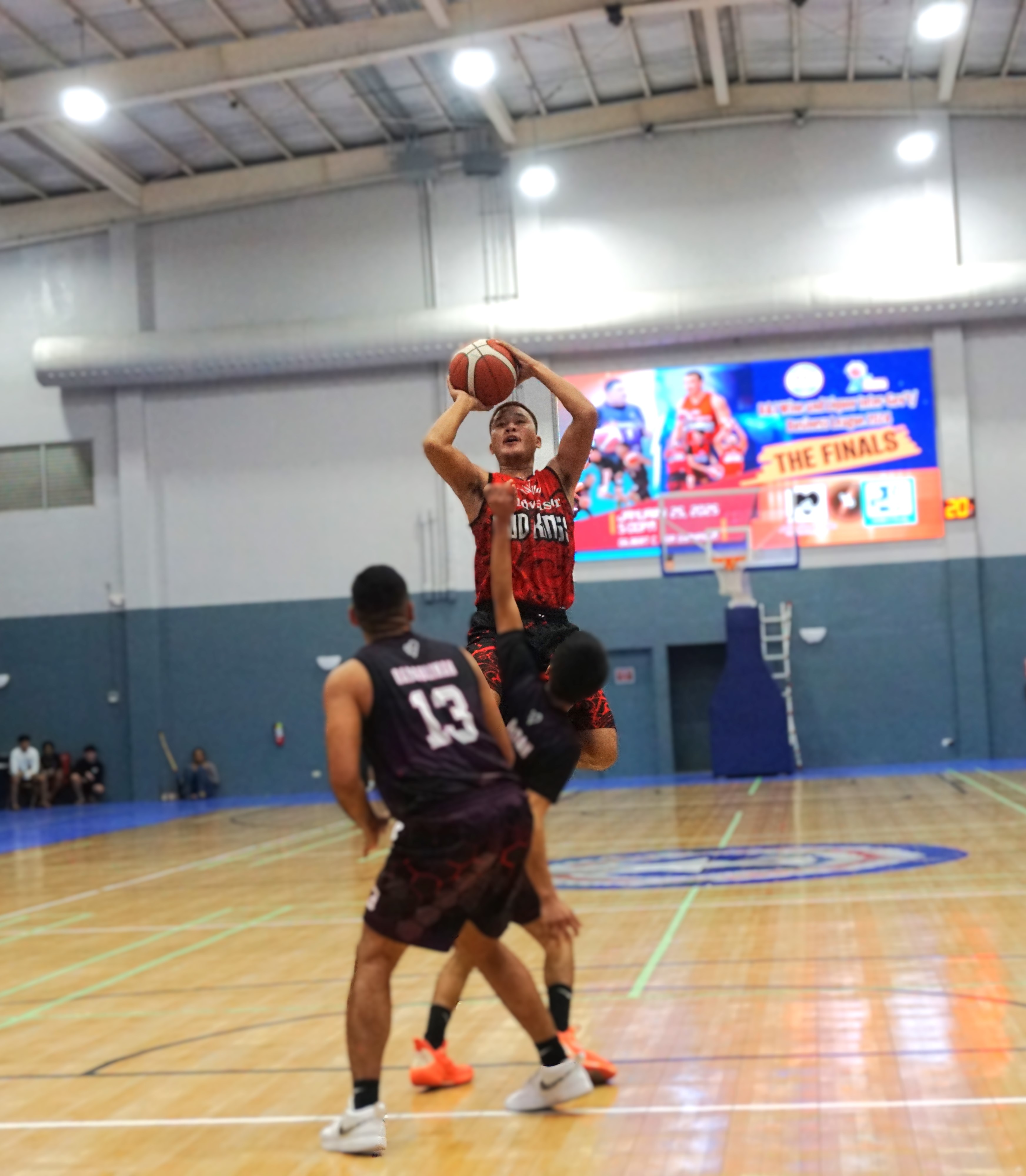 Marpac's Coby Santos pulls up over two defenders for the jump shot.