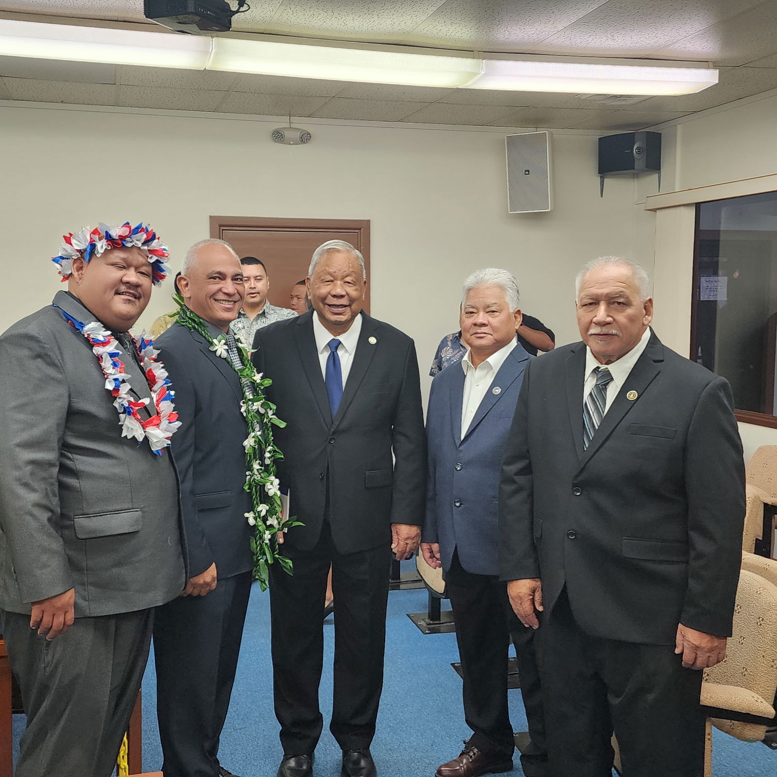 Gov. Arnold I. Palacios, second right, and Lt. Gov. David M. Apatang, center, with Reps. John Paul Sablan, left, Joseph Flores, second left, and Roman Benavente, right, during a break from the organizational session on Monday.