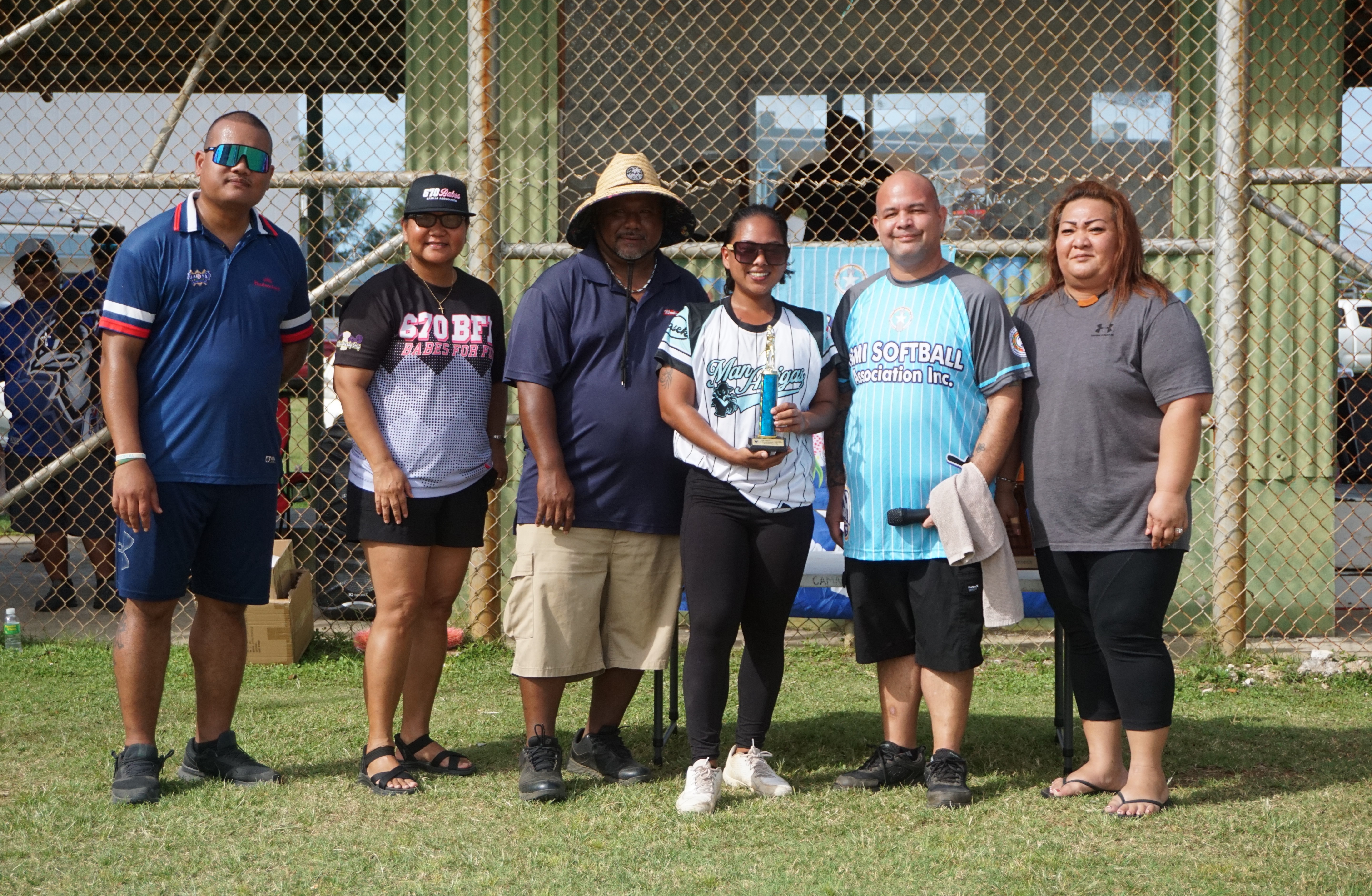 Jaylina Borja of the Man Amigas poses with the Most Runs and Most Singles awards with NMI Softball Association board members during the awards ceremony of the NMISA Women's Softball League 2024 at the Miguel “Tan Ge” Pangelinan Softball Field on Saturday.