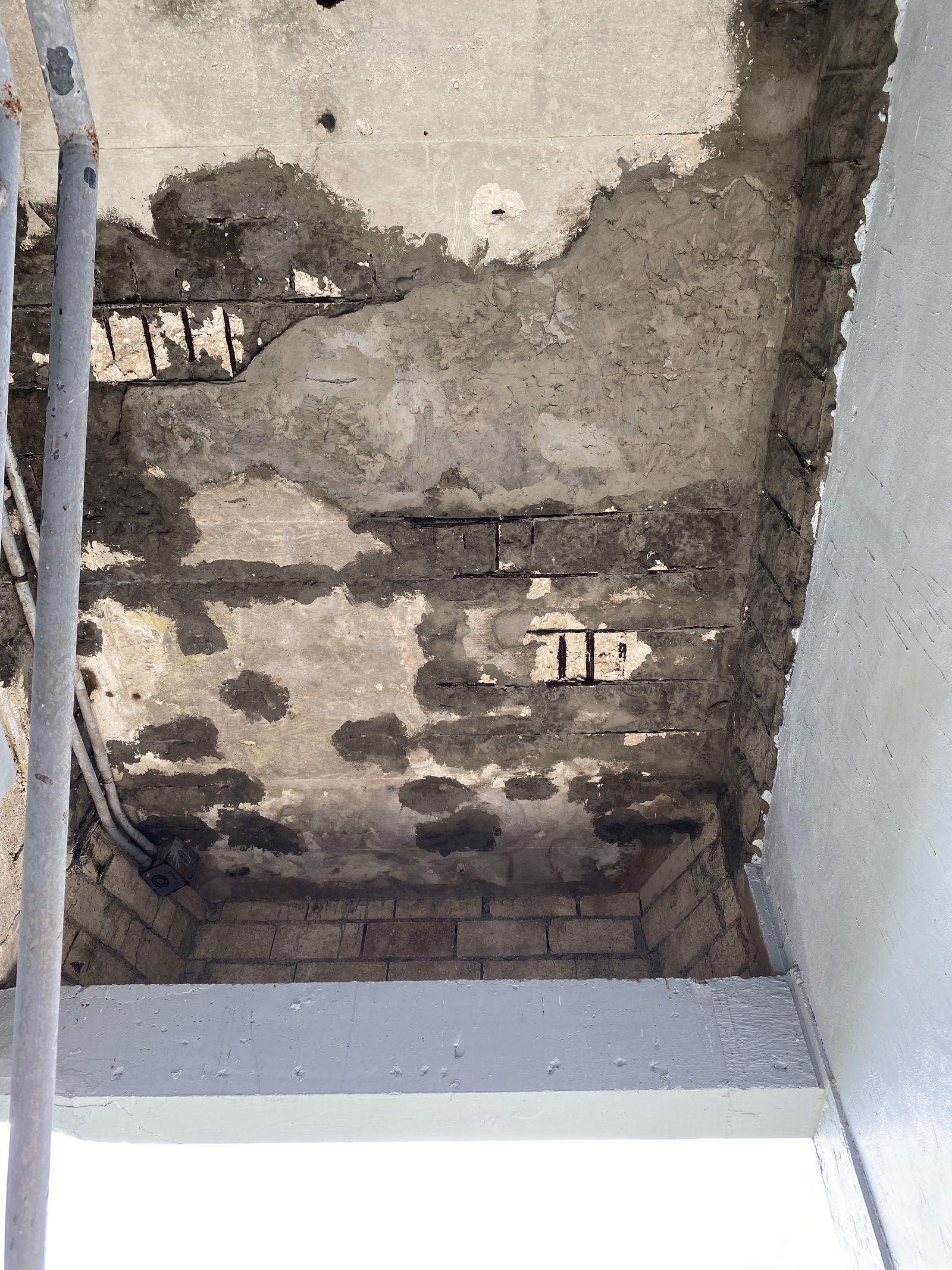 Exposed rebar is seen on the ceiling in the CIC building.